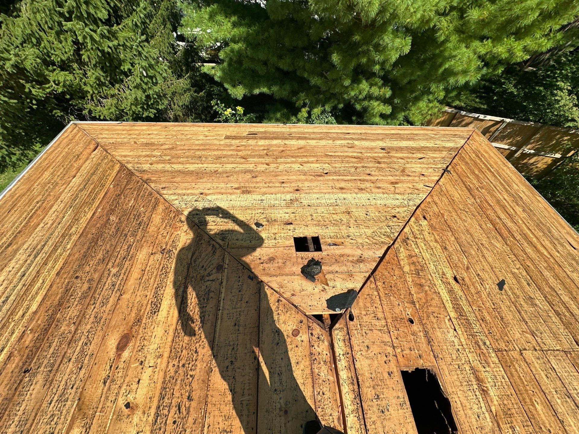 Bare board deck on the hip end of the roof, with open vent holes, Fairborn, Ohio.