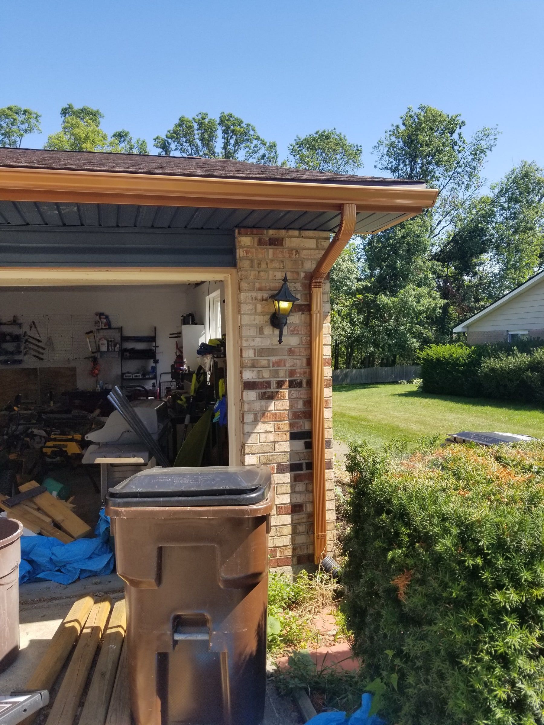 A copper-colored downspout and gutter at the garage, Beavercreek, Ohio.