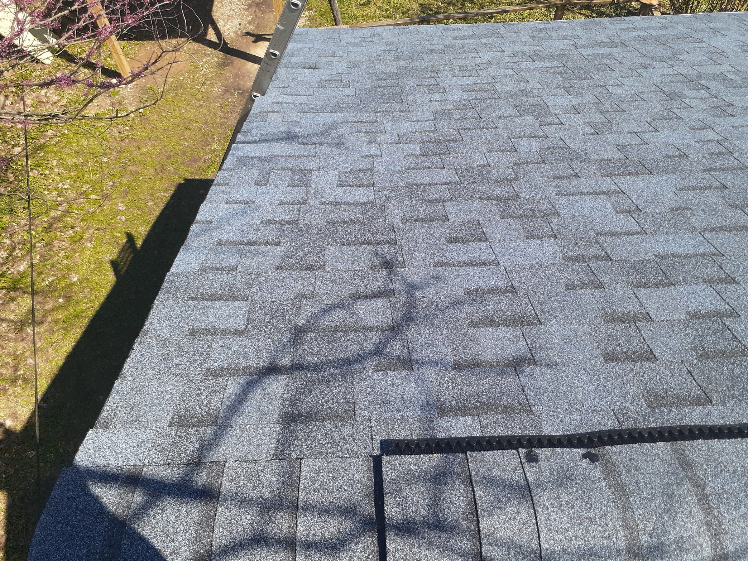 A finished slope down to the eave, with tree shadows across it, Yellow Springs, Ohio.