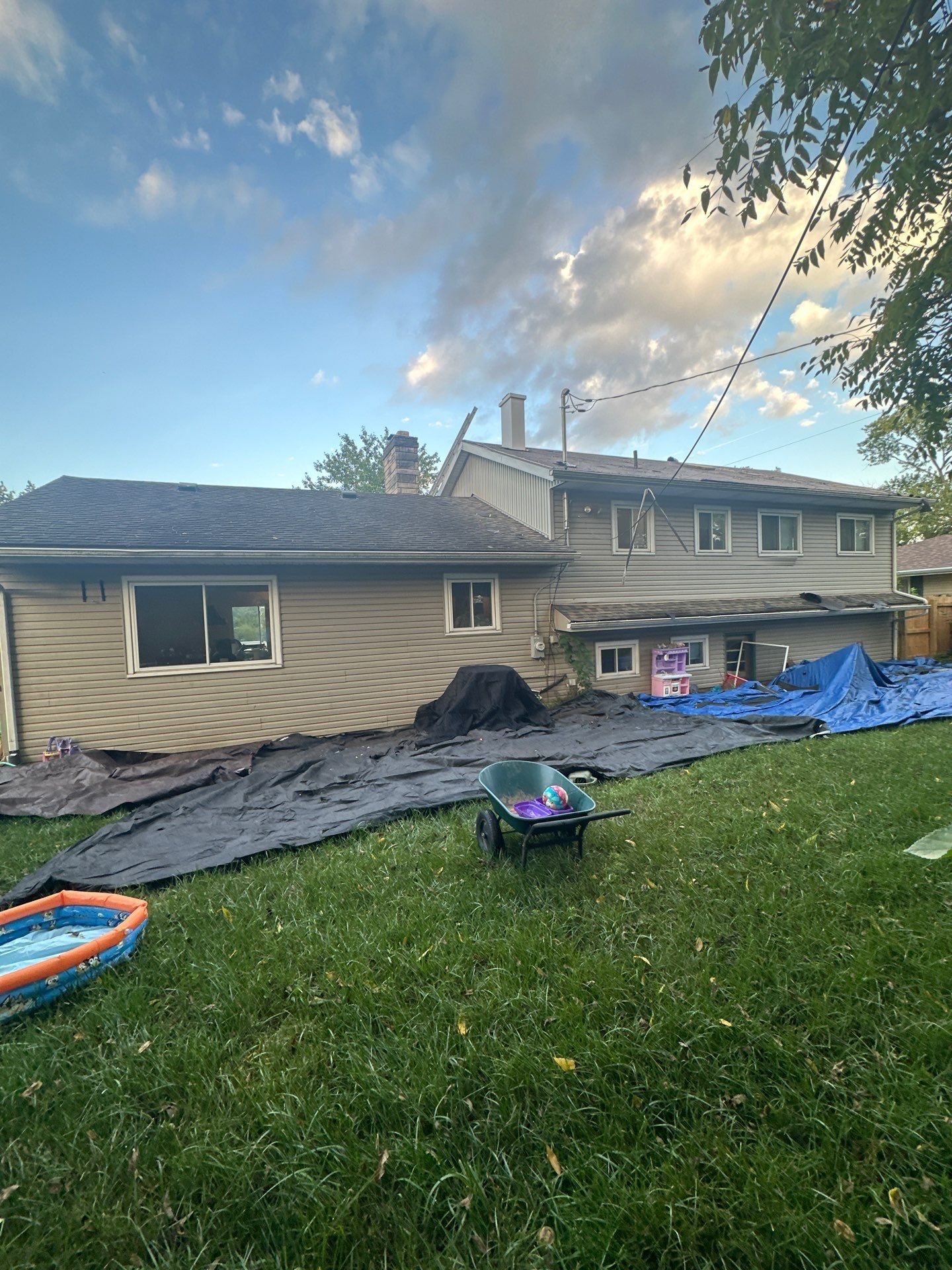 Tarps spread across the back yard below the roof, Fairborn, Ohio.