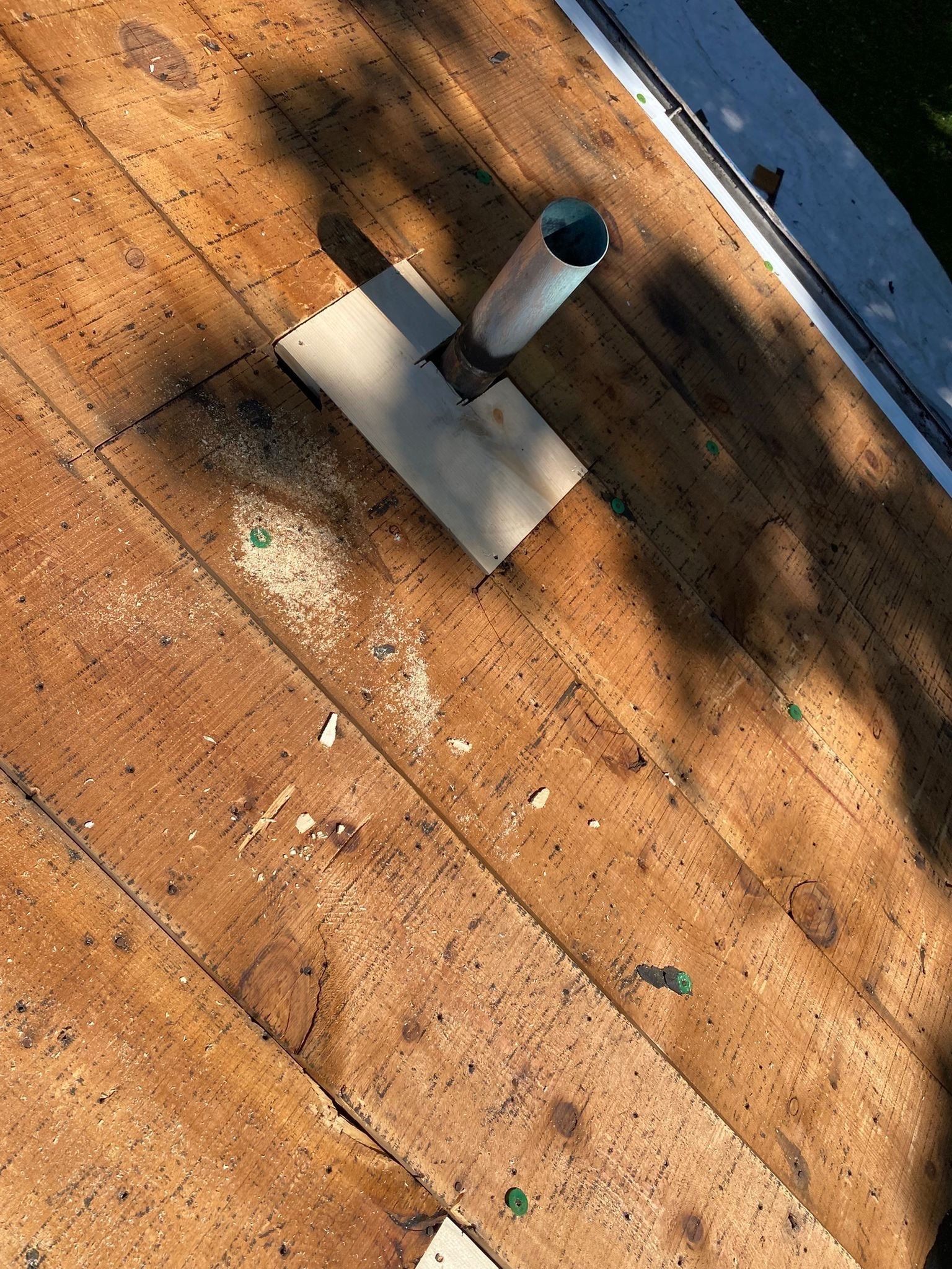 Plumbing vent pipe standing on the clean deck before new underlayment, Beavercreek, Ohio.