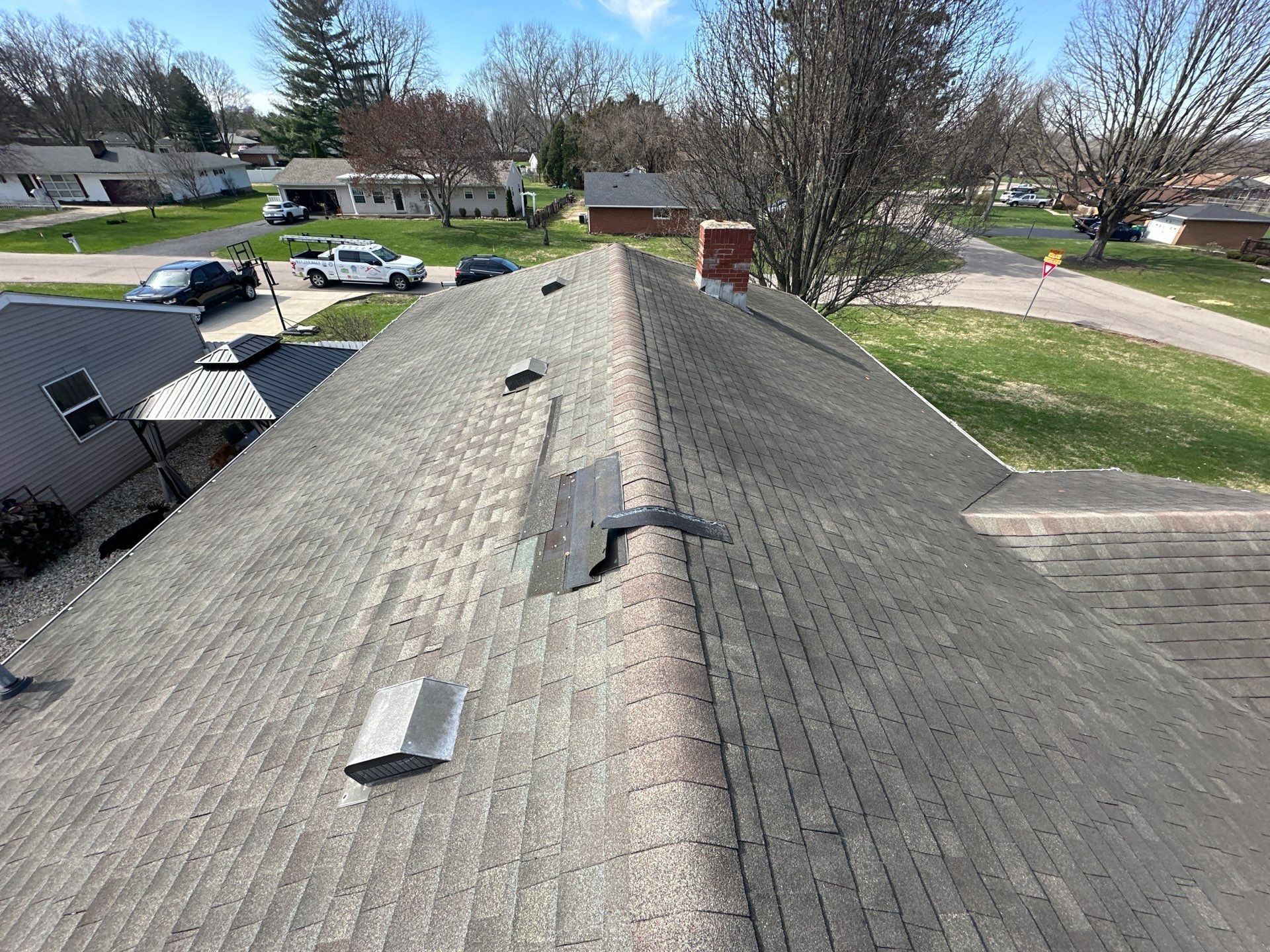 Wind-damaged shingles lifted along the ridge, from the drone, Beavercreek, Ohio.