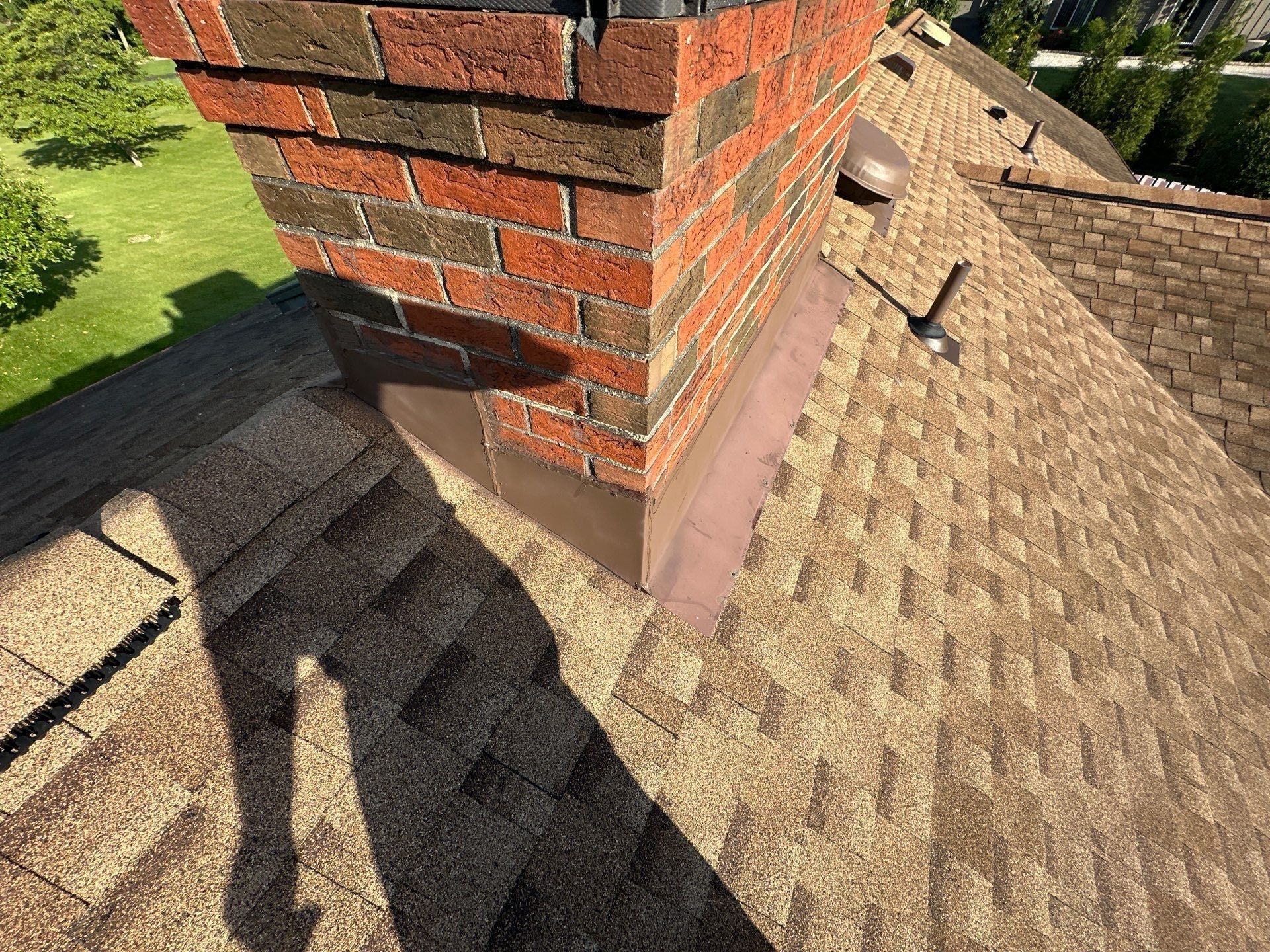 The brick chimney and new shingles on the repaired slope, Clayton, Ohio.