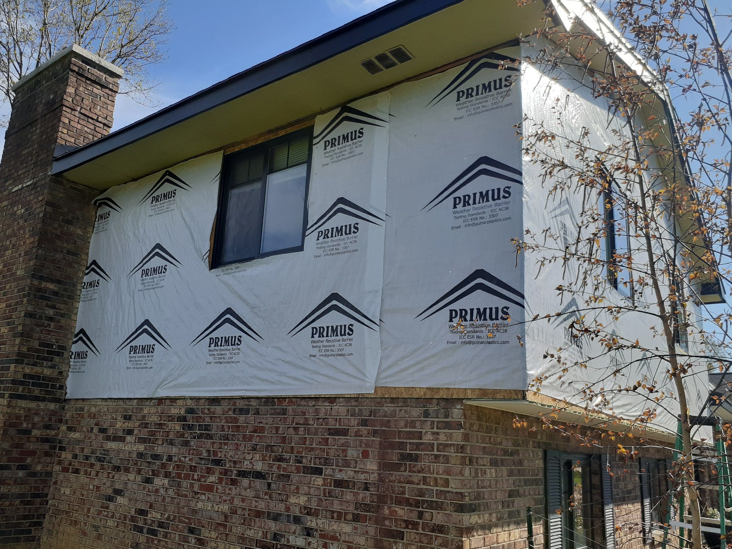 House wrap around the window on the chimney side, Beavercreek, Ohio.