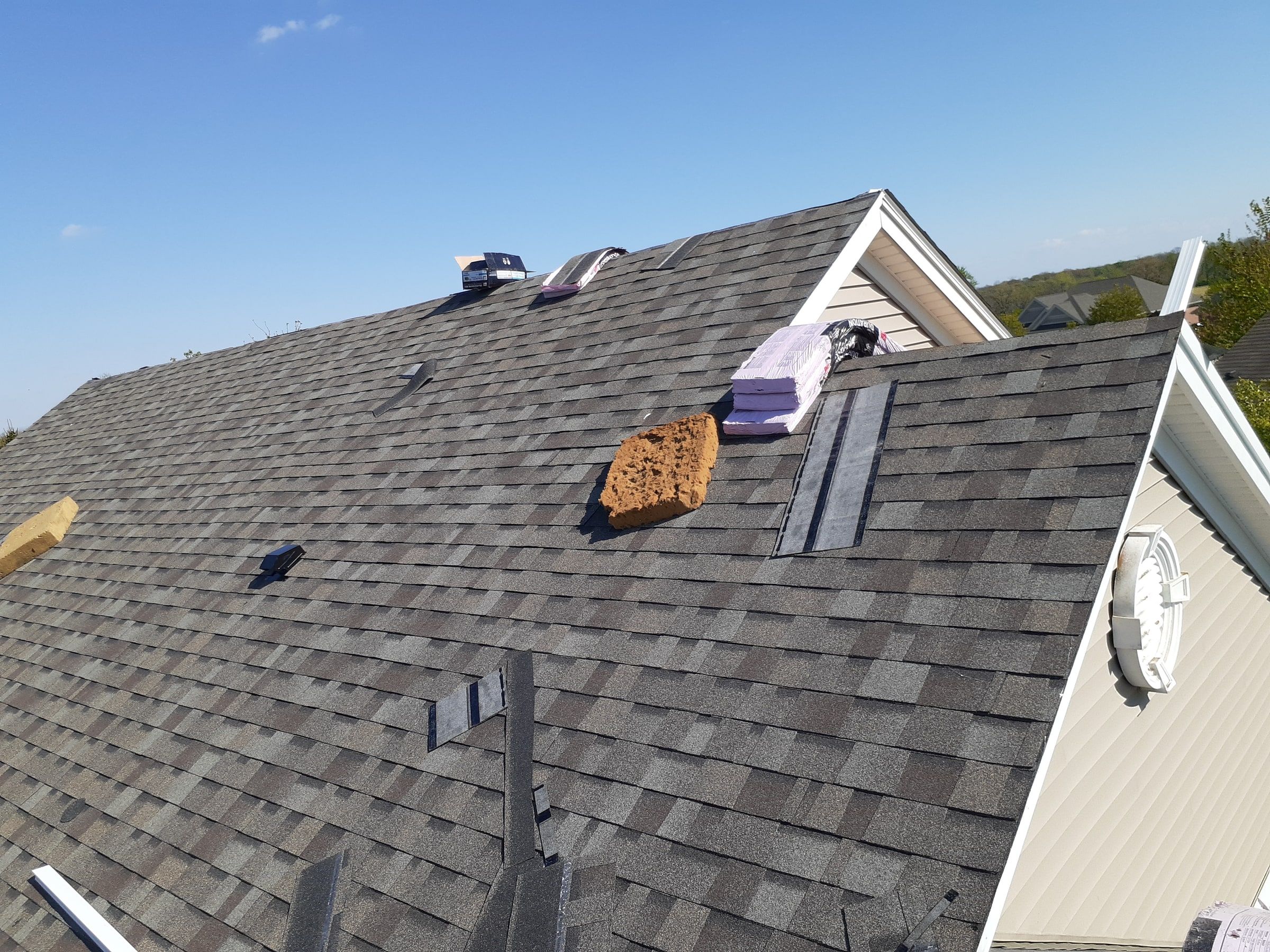 New shingles going on beside the siding of the garage, Xenia, Ohio.