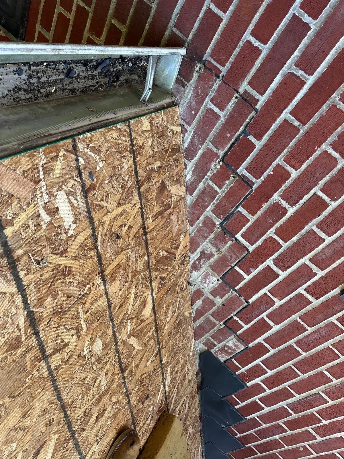 The deck where the lower roof meets the brick wall, before underlayment, Beavercreek, Ohio.