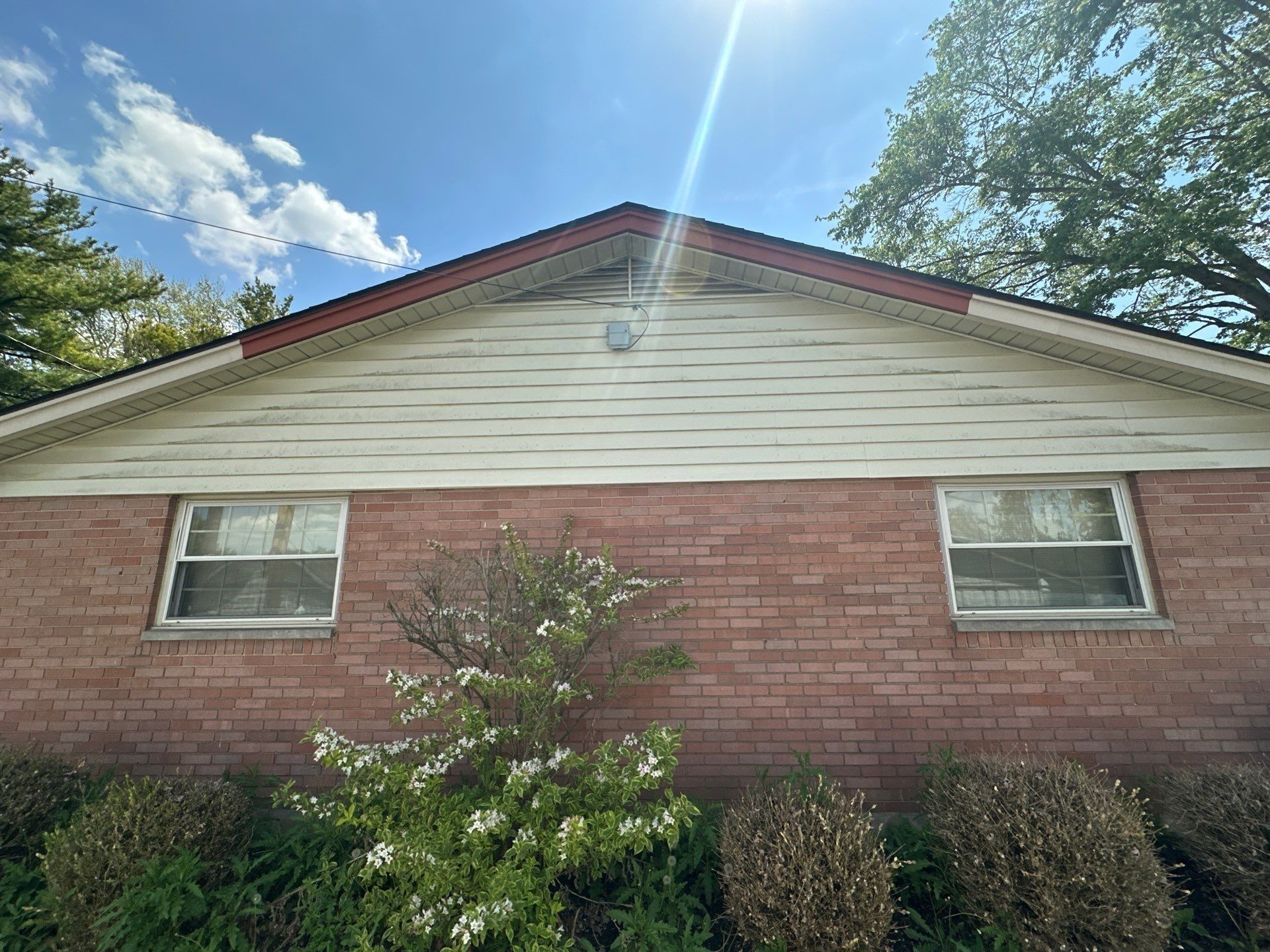 Wind-torn fascia along the second gable, Kettering, Ohio.