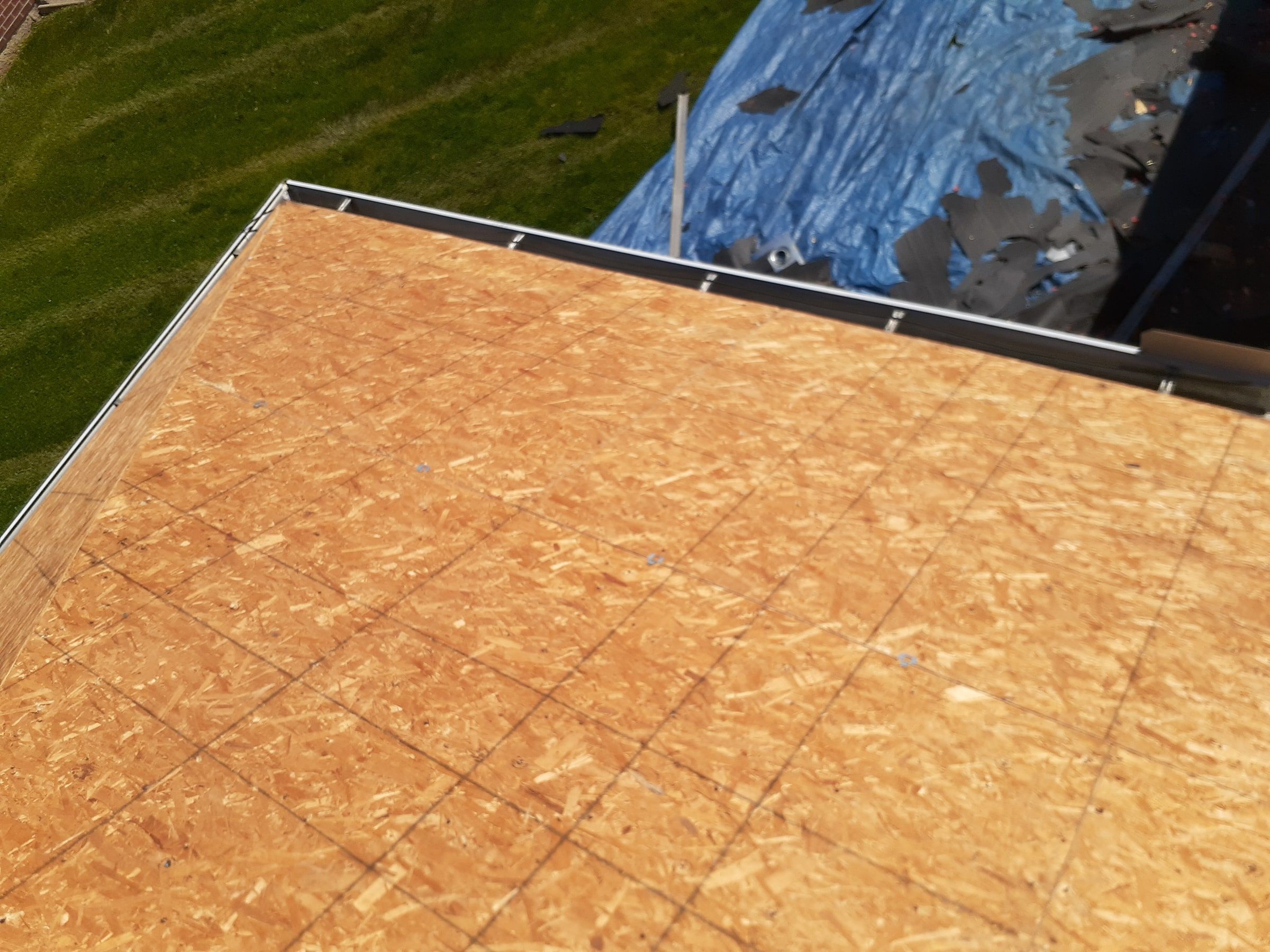 New sheathing and debris on the tarp below