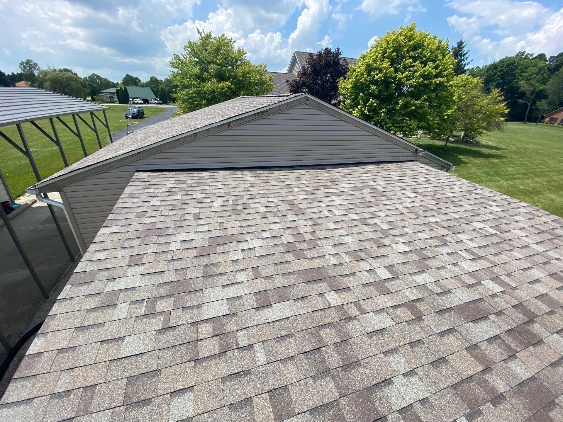 Detached garage roof finished beside the metal carport, Yellow Springs, Ohio.