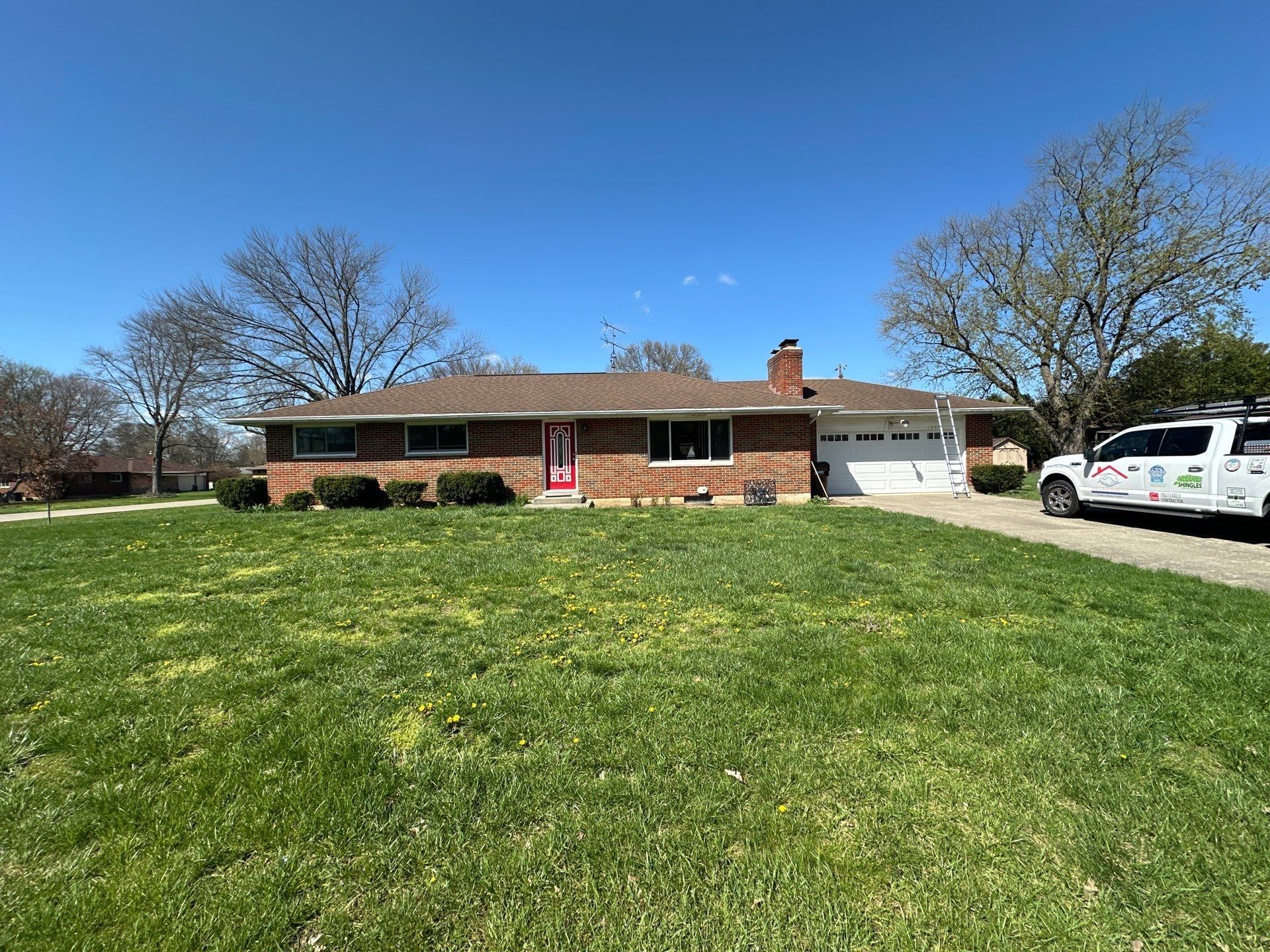 Brick ranch house with an older brown shingle roof before replacement, Beavercreek, Ohio.
