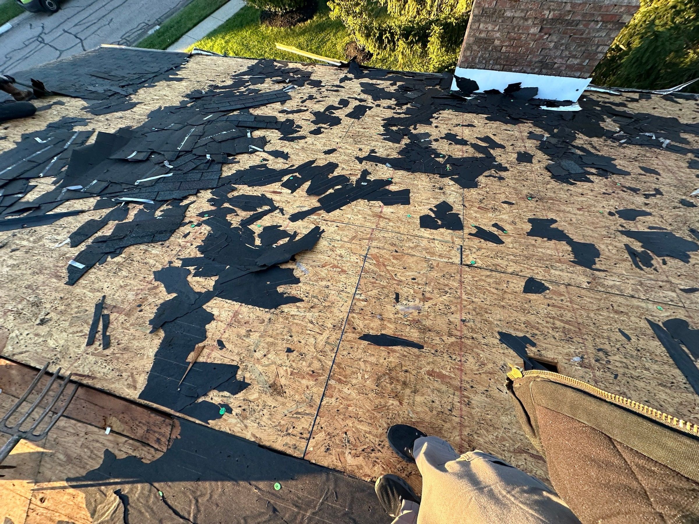 Scraps of old shingle across the bare deck near the chimney, West Carrollton, Ohio.