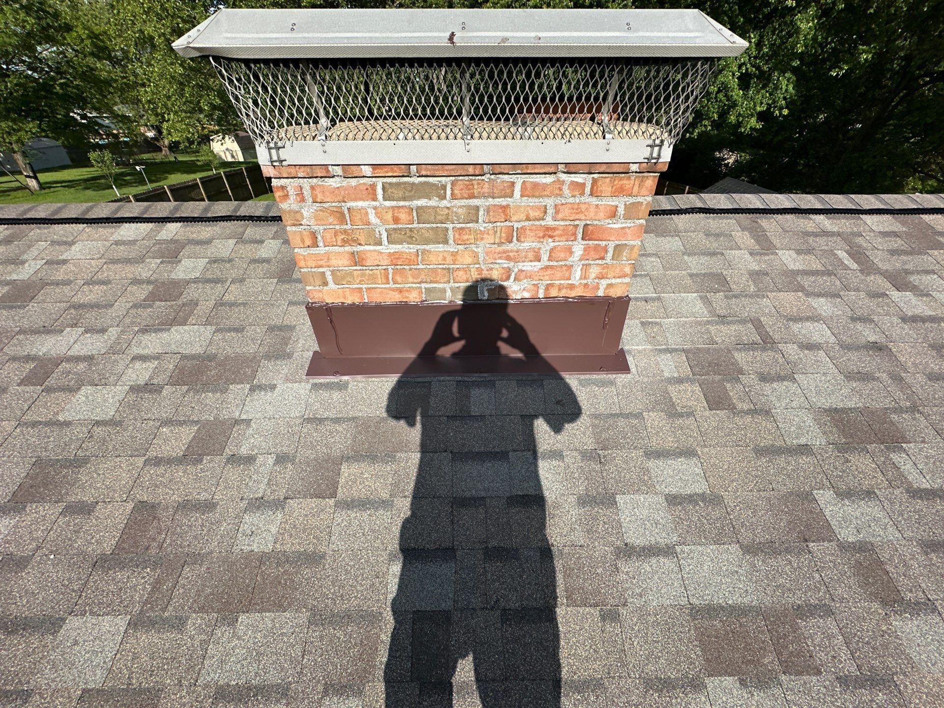 The brick chimney with new brown flashing at its base, Beavercreek, Ohio.