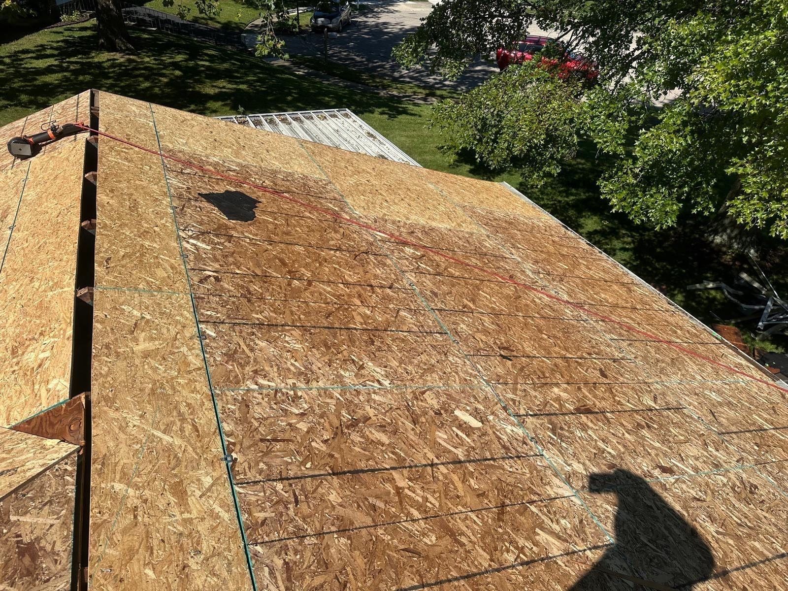 New OSB sheets nailed down across a slope, West Carrollton, Ohio.