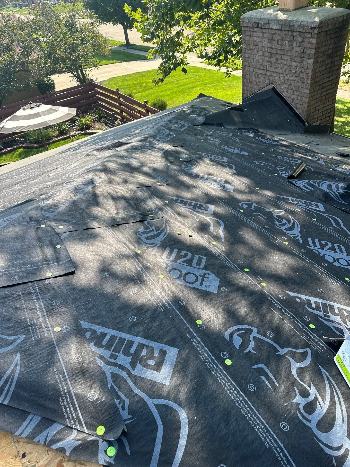 Ice and water shield and synthetic underlayment up to the brick chimney, Dayton, Ohio.