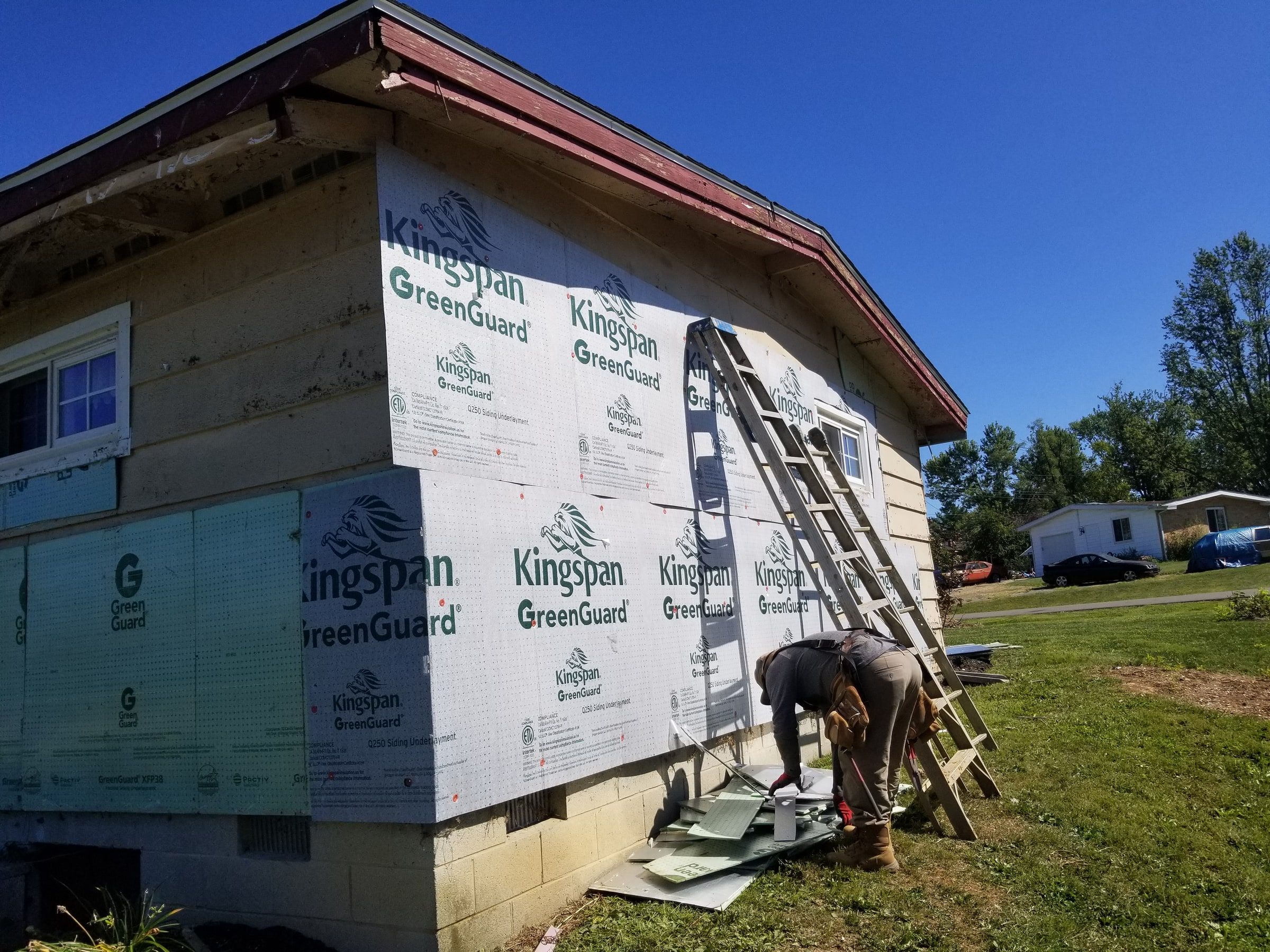 Fanfold board going up the gable end, with a ladder against the wall, Beavercreek, Ohio.