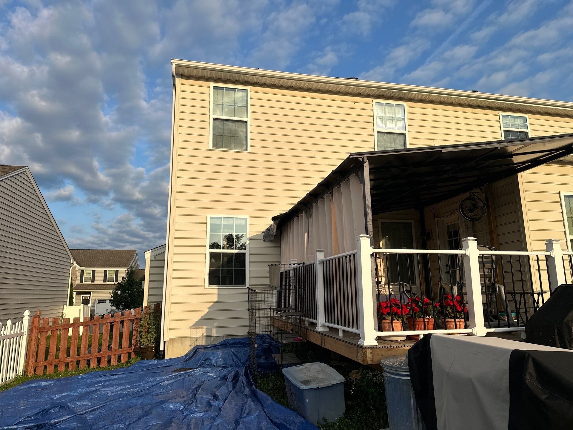 A tarp covering the ground behind the house below the deck, Xenia, Ohio.