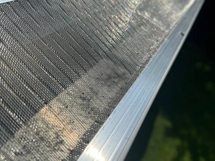 Close view of the stainless steel mesh gutter guard screwed to the front of the new gutter, Kettering, Ohio.