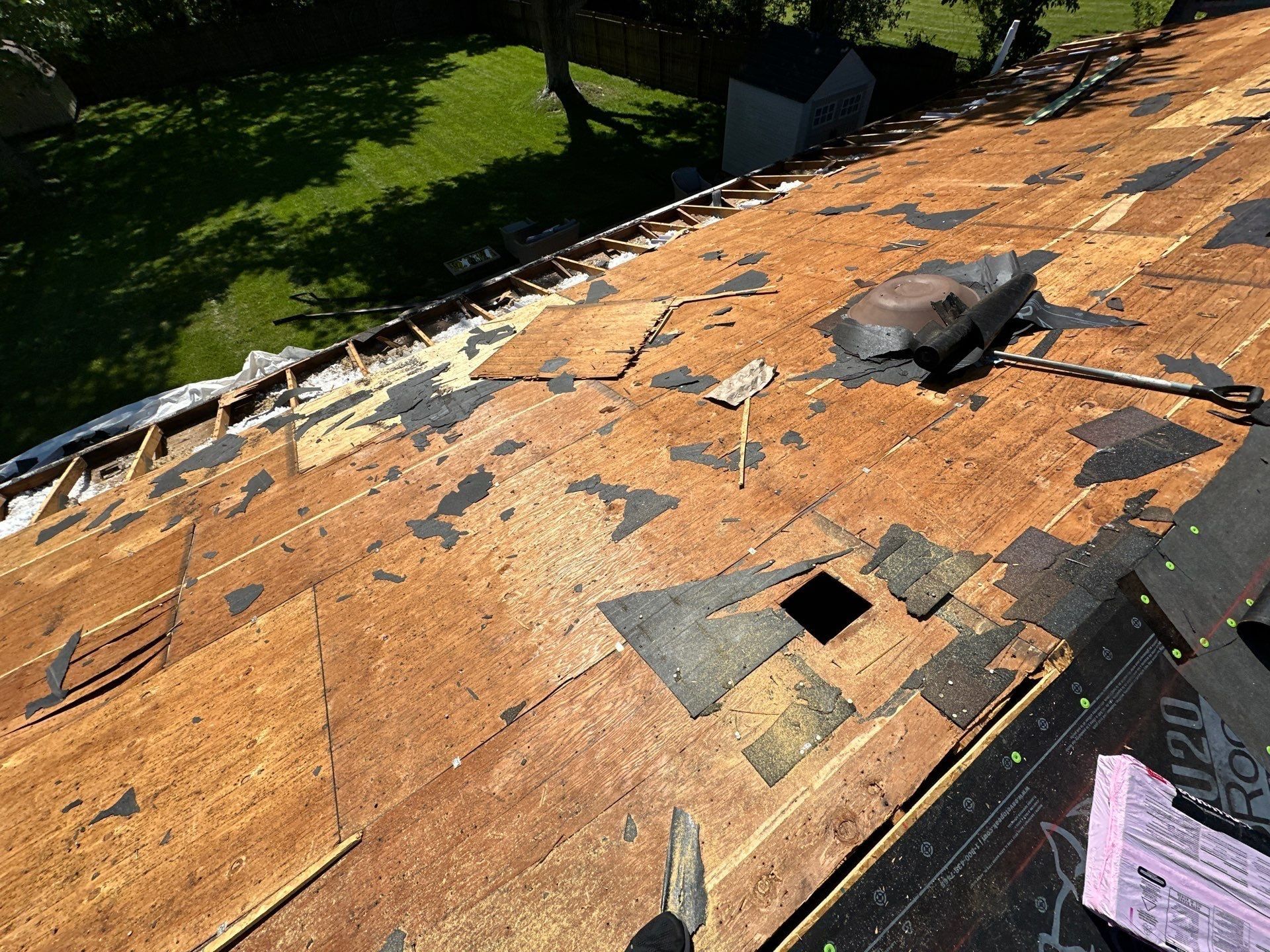 The back slope stripped to the deck while the front gets new shingles, Beavercreek, Ohio.