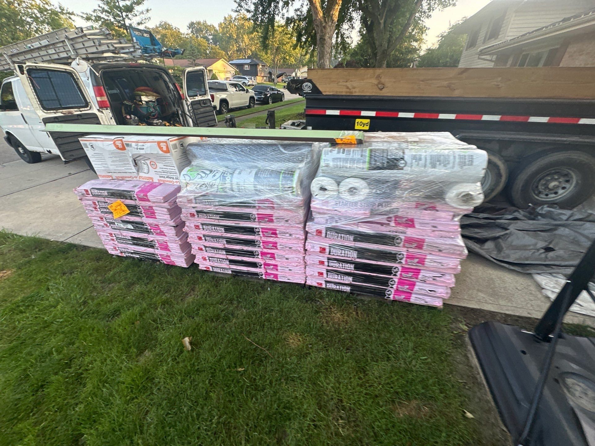 Owens Corning Duration bundles and underlayment rolls lined up on the driveway by the trailer, Dayton, Ohio.