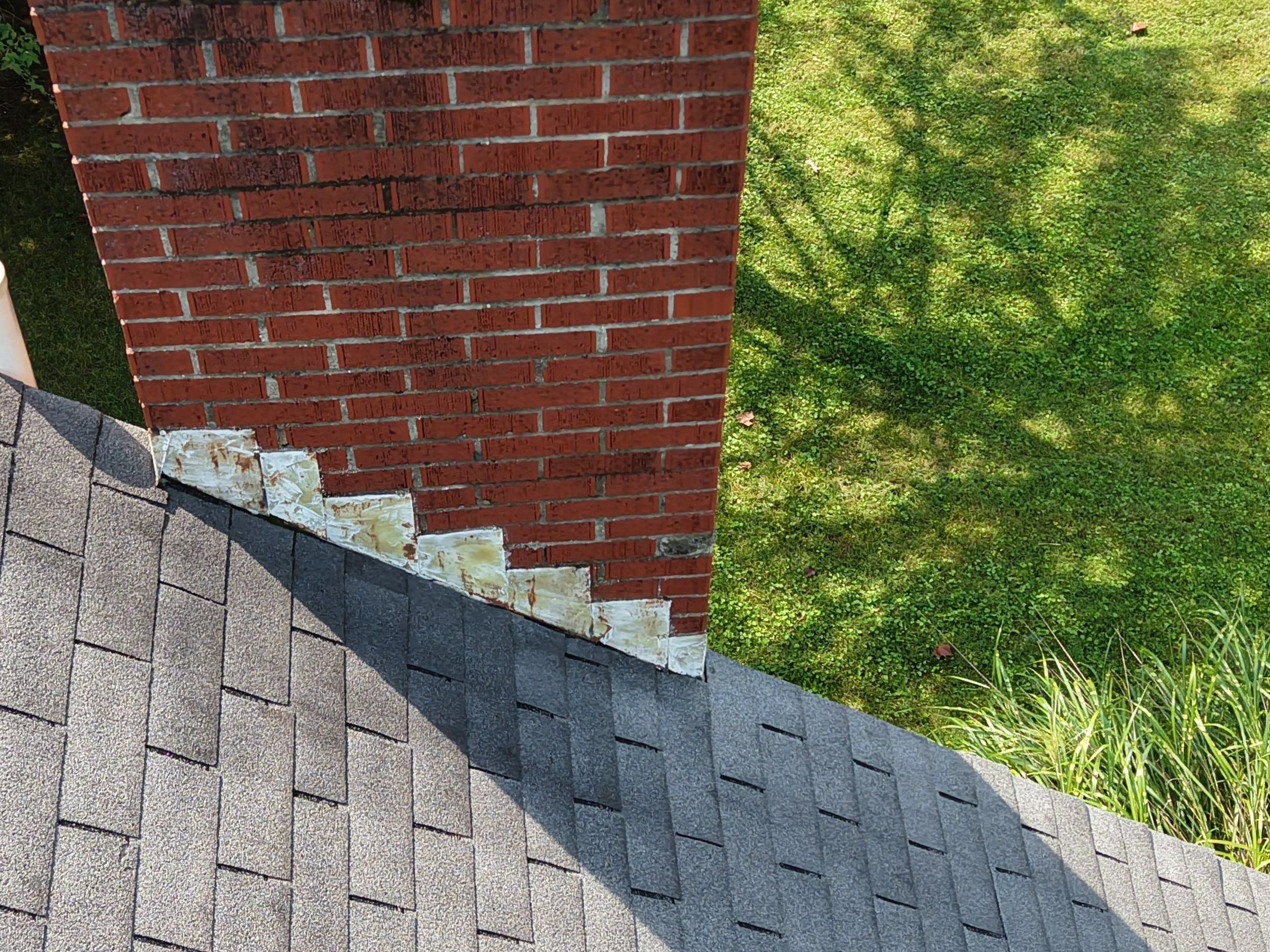 Old step flashing along the side of the brick chimney, Beavercreek, Ohio.