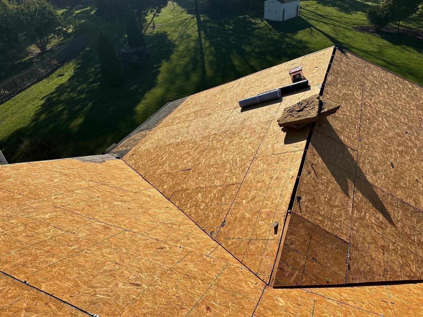 The bare deck where two roof sections meet, with a vent pipe, Beavercreek, Ohio.