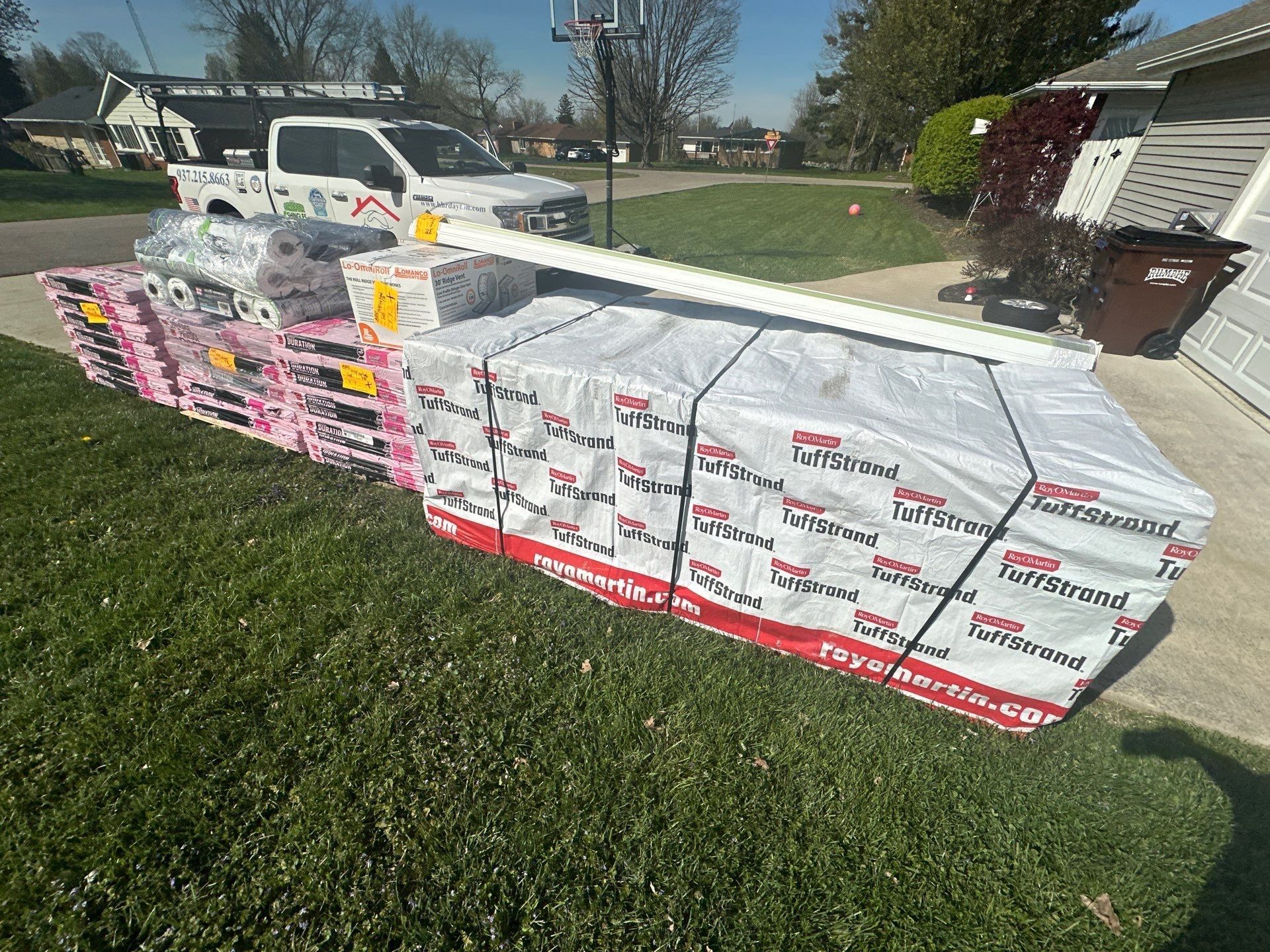 OSB sheathing and shingles delivered and stacked on the lawn, Beavercreek, Ohio.