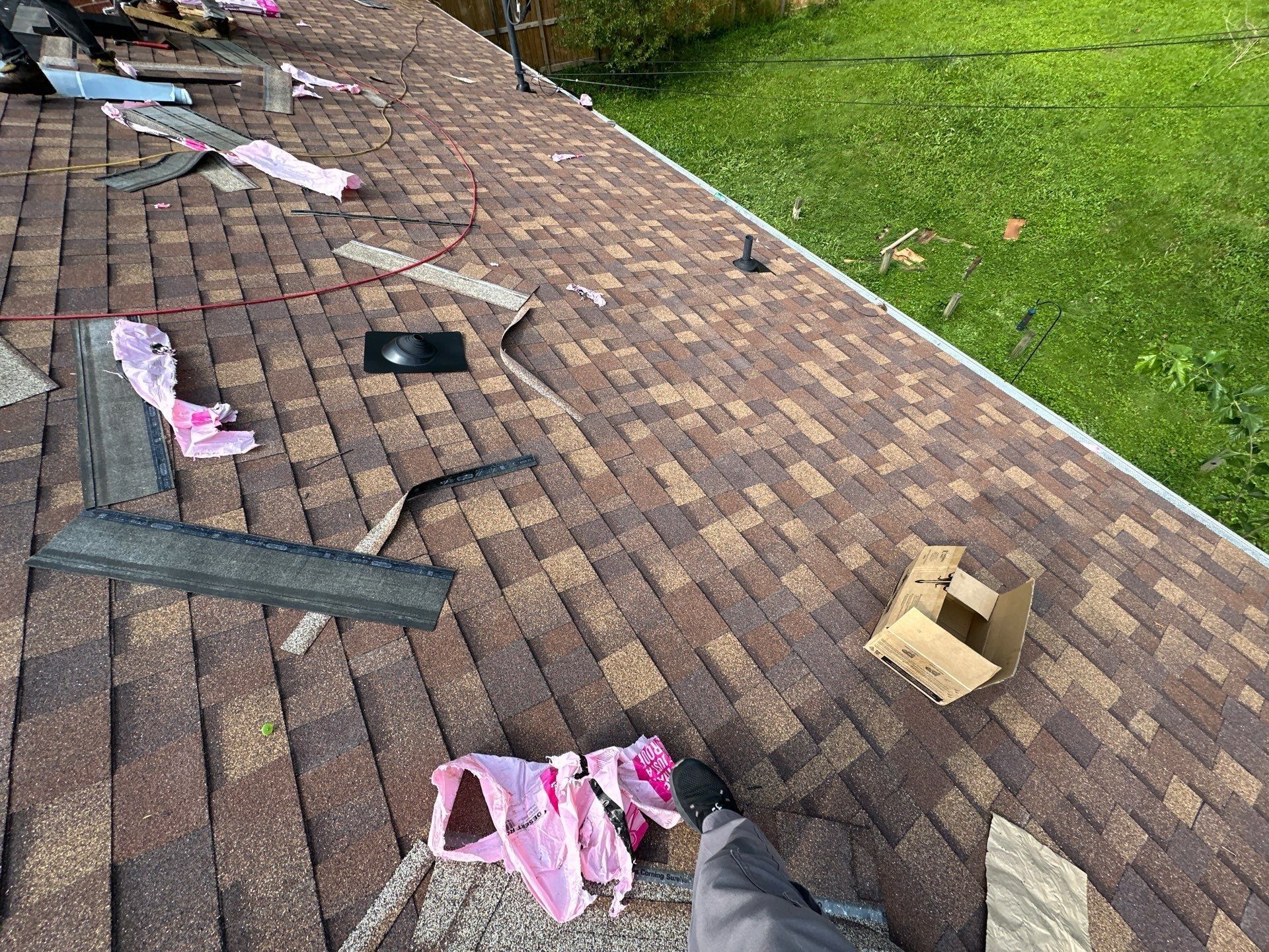 New shingles laid around a vent pipe, with starter strip offcuts nearby, Fairborn, Ohio.