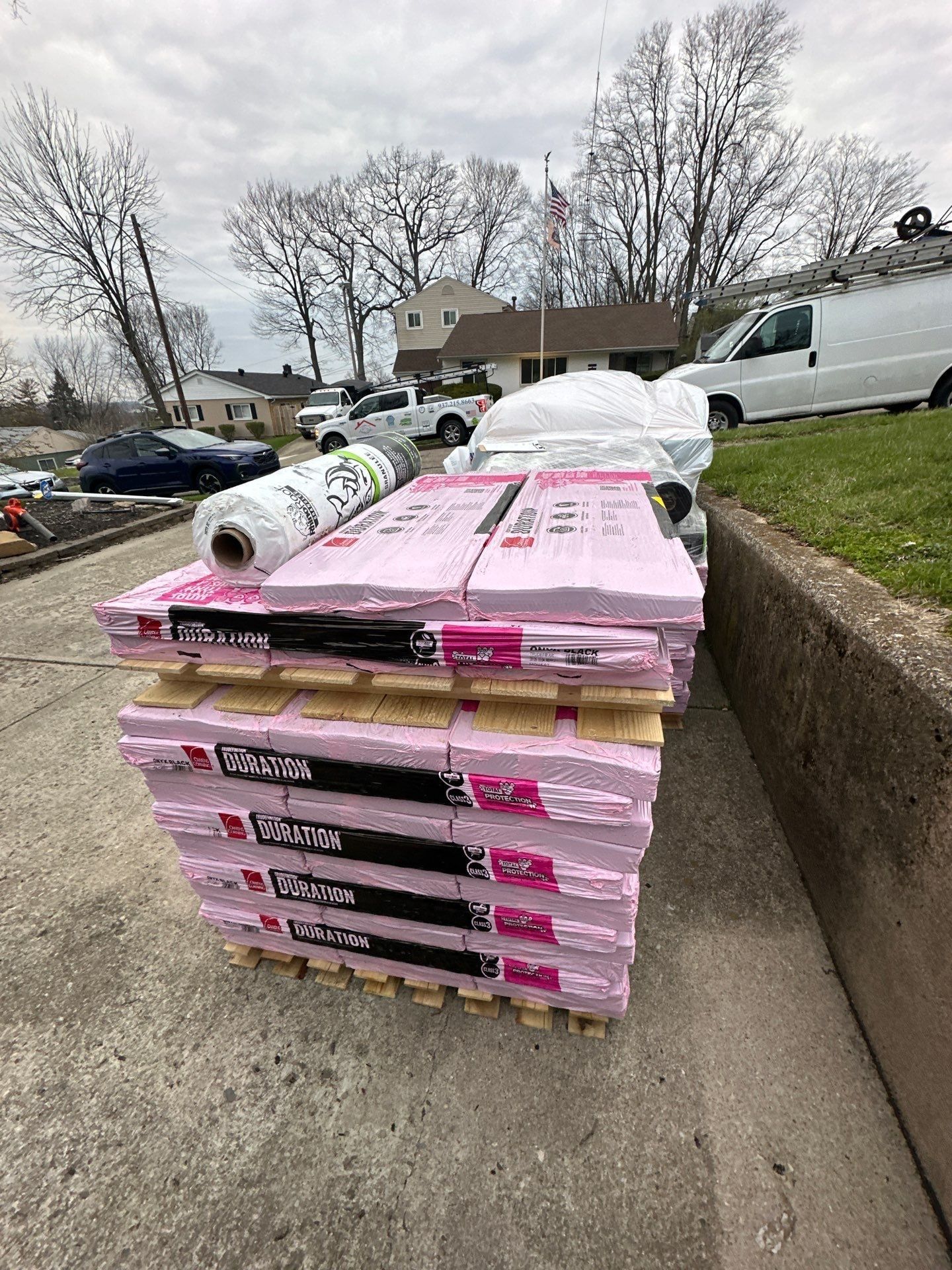Duration bundles and underlayment rolls at the curb