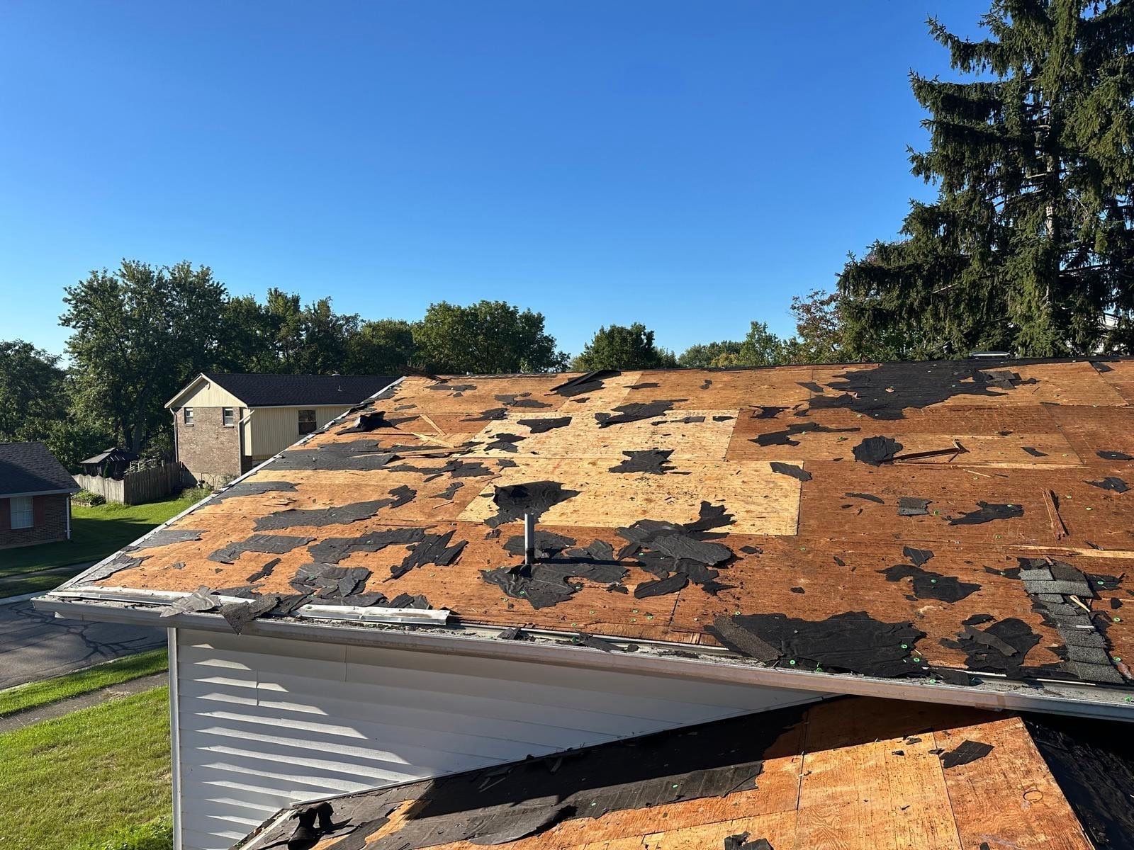 The upper roof torn off, with patches of old underlayment left on the deck, West Carrollton, Ohio.