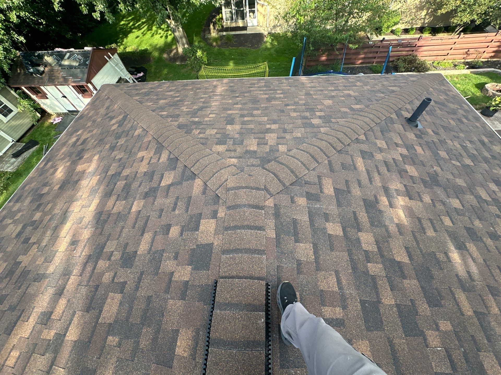 The finished hip roof with its ridge cap and a vent pipe, seen from the top, Dayton, Ohio.