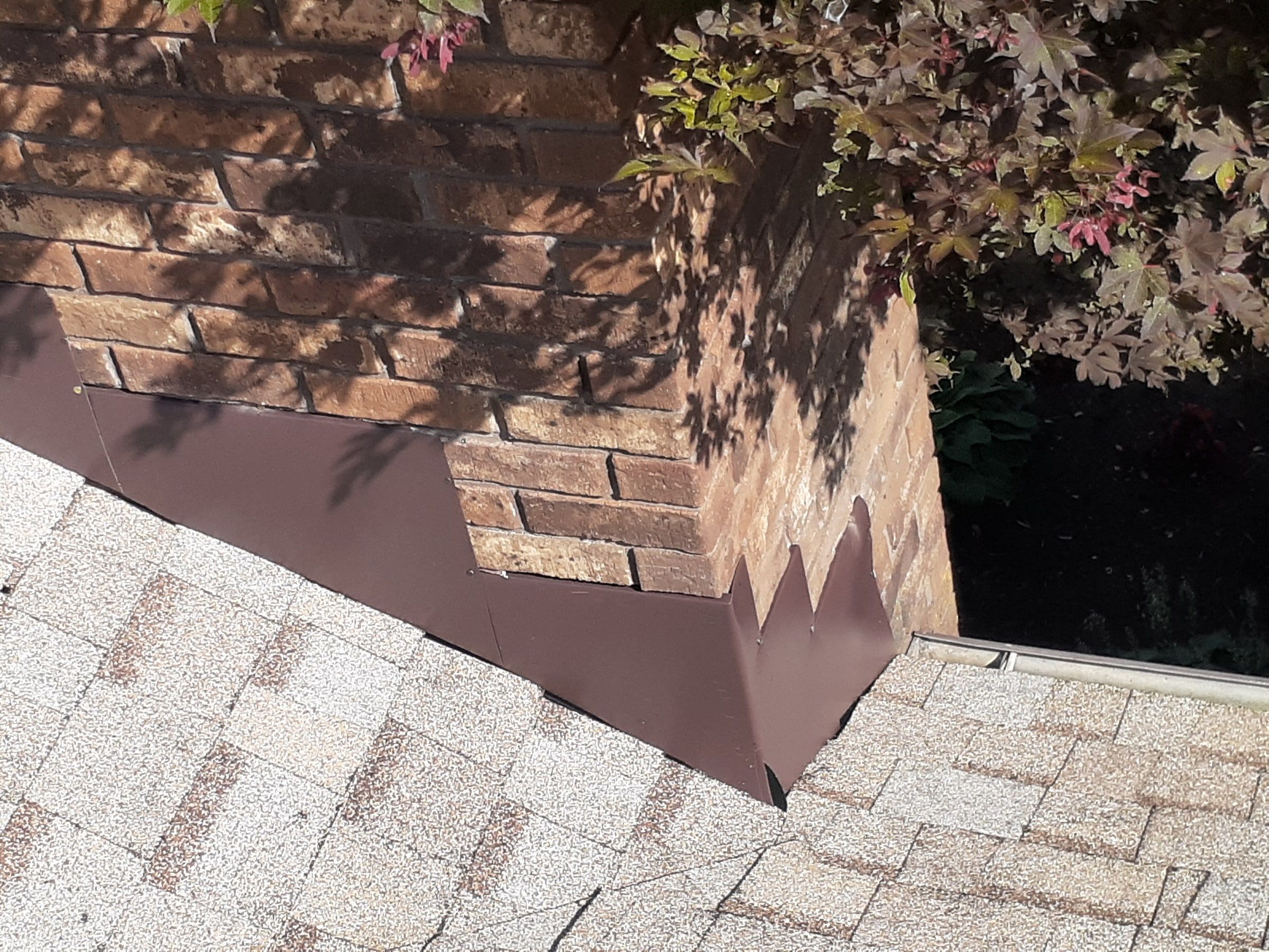 Stepped metal flashing set into the mortar on the chimney side, Jamestown, Ohio.