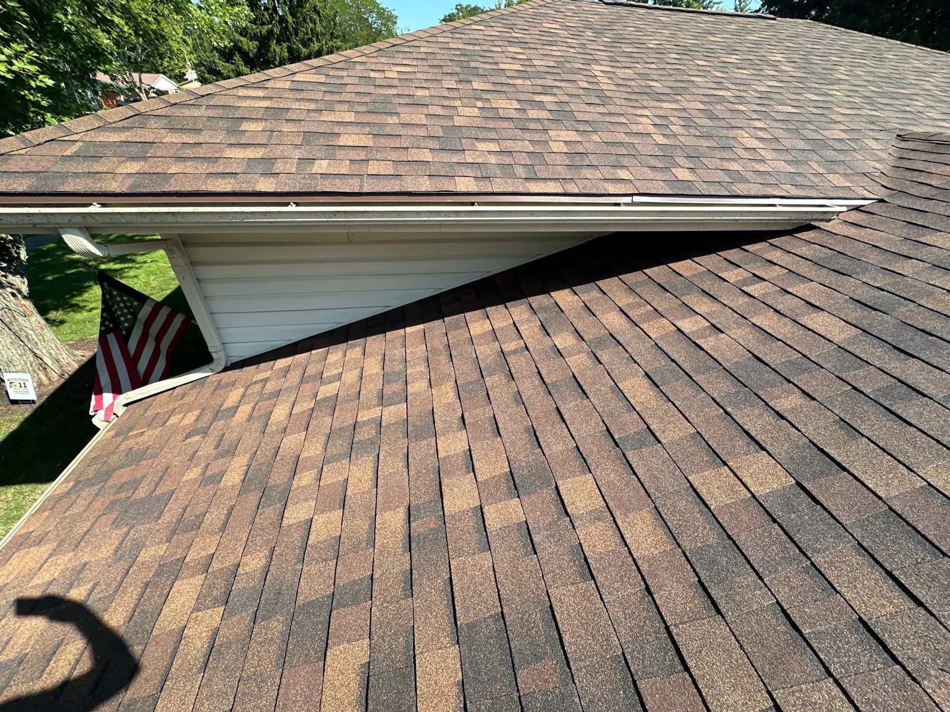 The finished lower roof below the house wall, with a flag by the driveway, Dayton, Ohio.