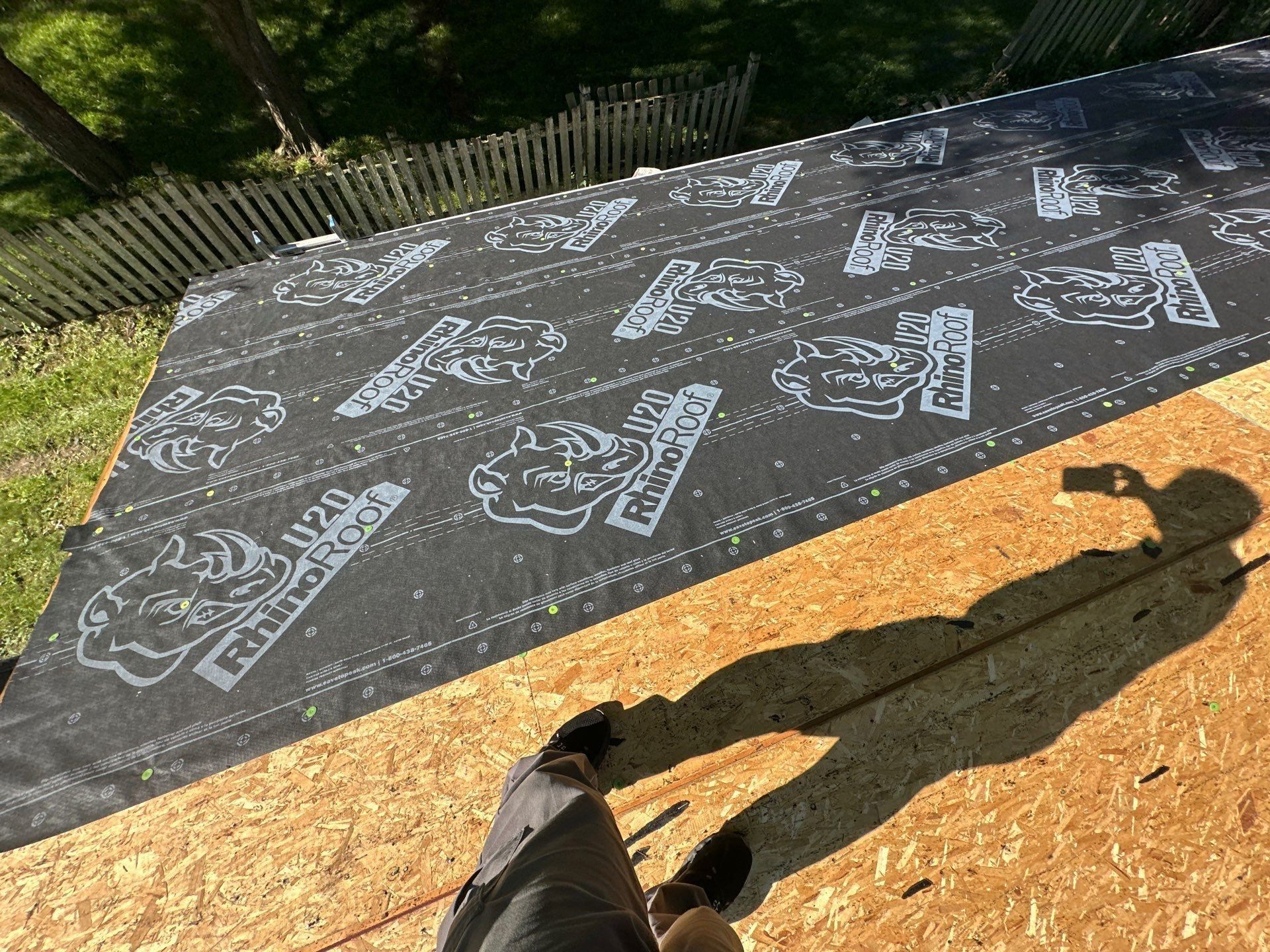 Synthetic underlayment going down over the OSB deck on the garage, Beavercreek, Ohio.