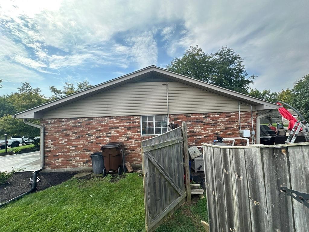 The gable side in new siding, above the brick, Beavercreek, Ohio.