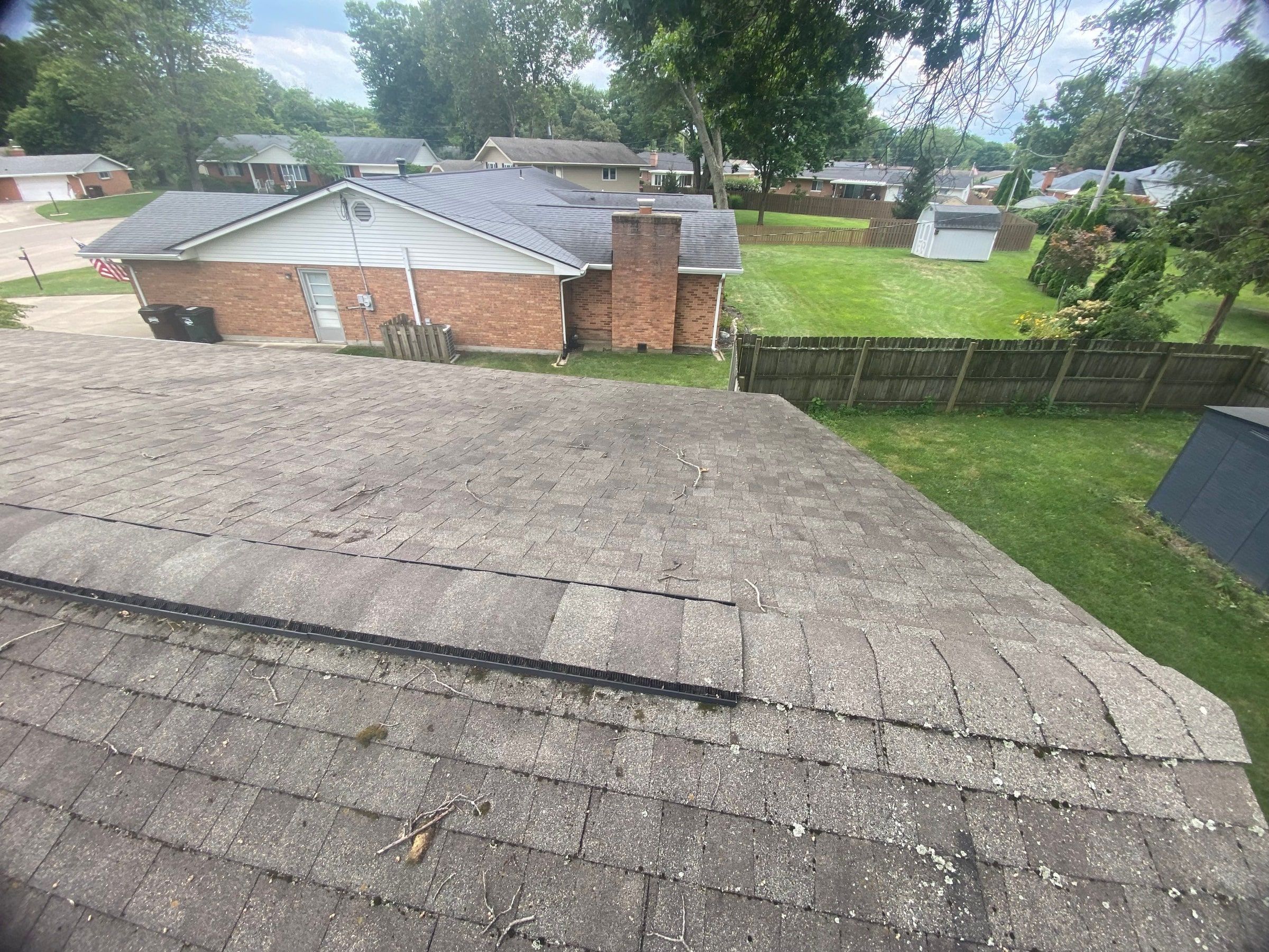 The older three-tab roof and the neighborhood behind it, Kettering, Ohio.