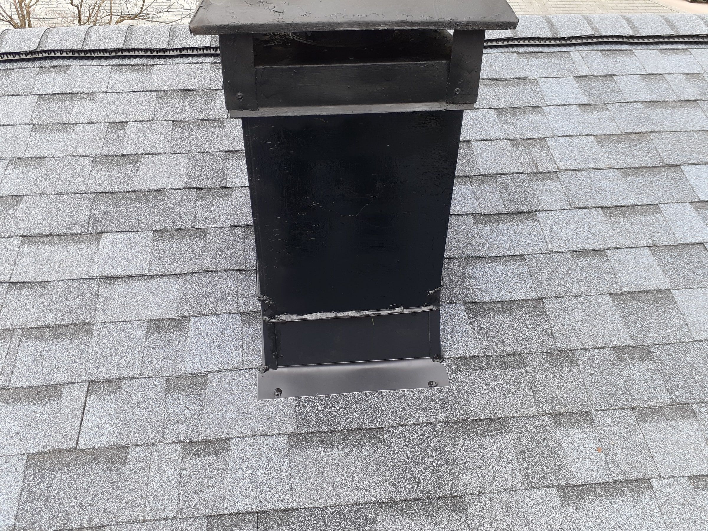 The chimney with its new black flashing on the finished roof, Kettering, Ohio.