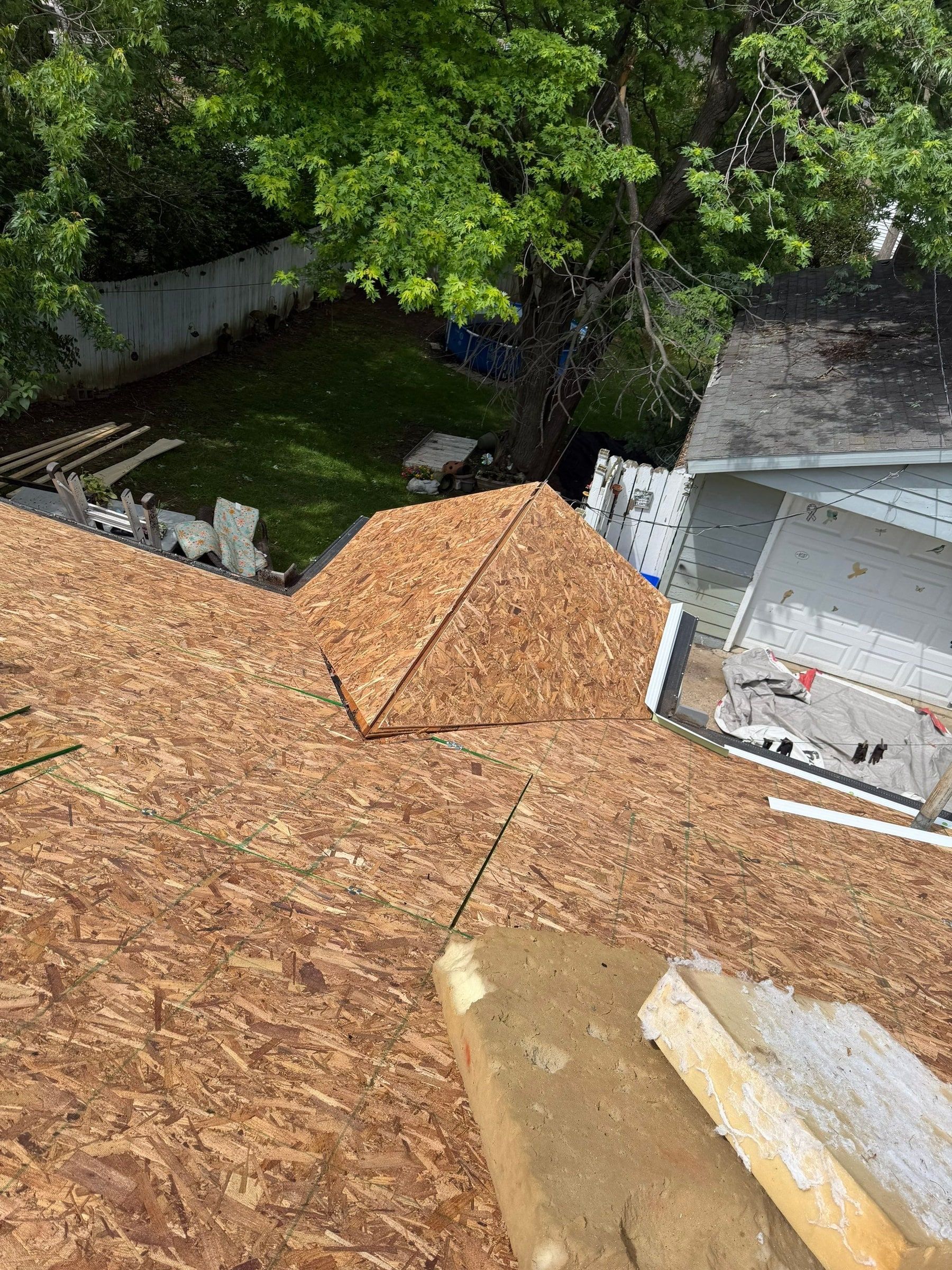 New OSB sheathing covering the roof up to a small gable, Dayton, Ohio.