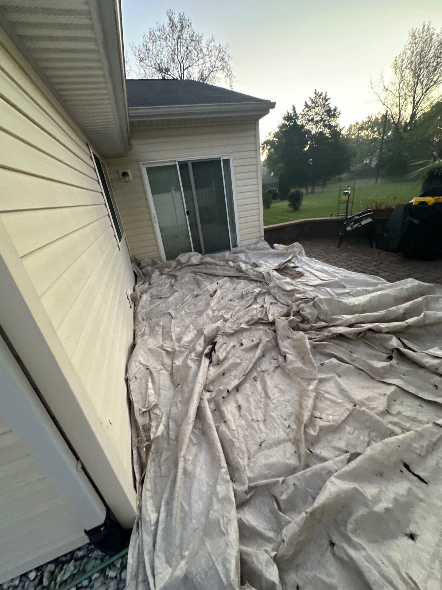 Tarps laid over the patio along the back of the house, Beavercreek, Ohio.