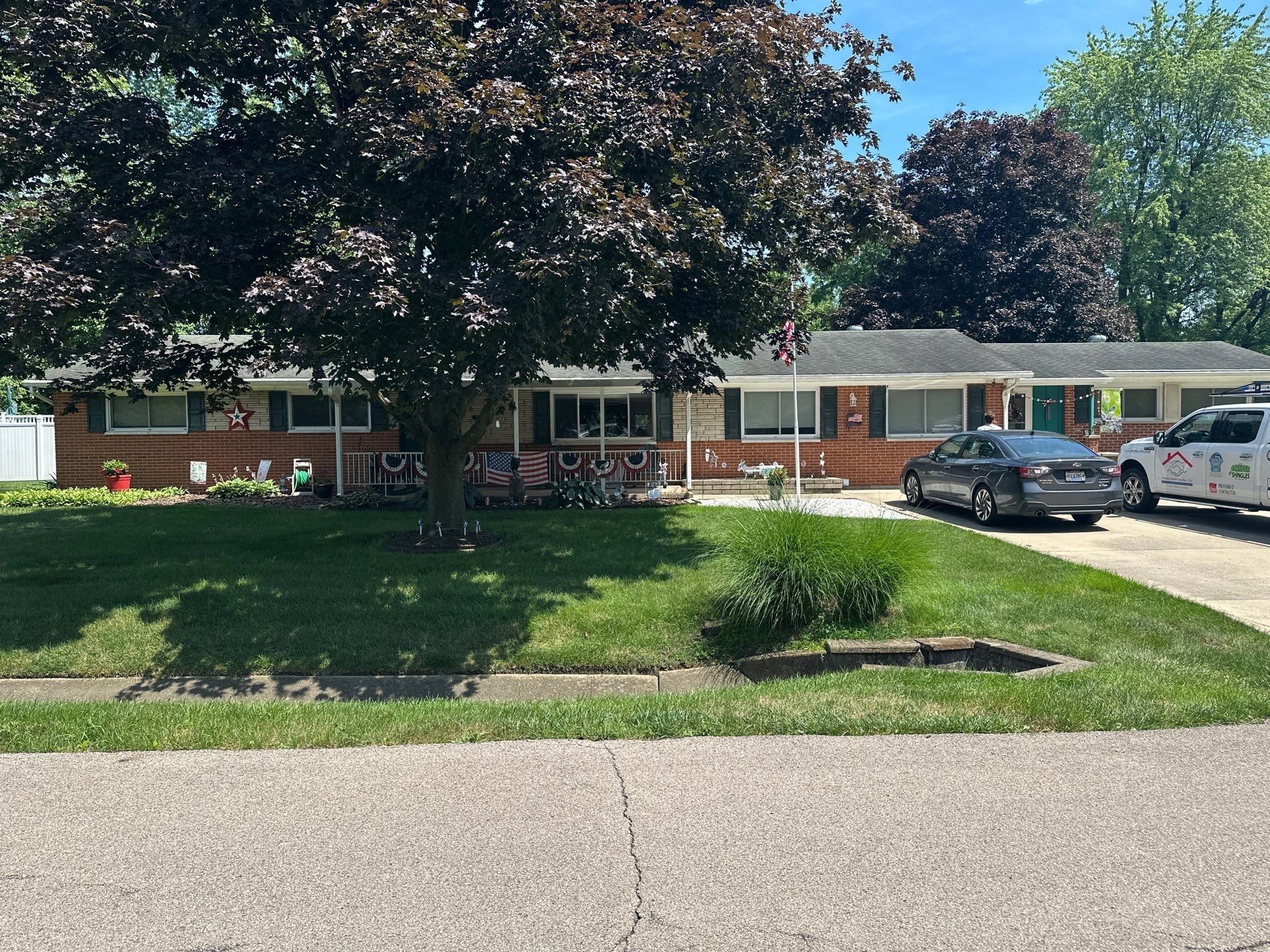 Brick ranch, shade tree and work van