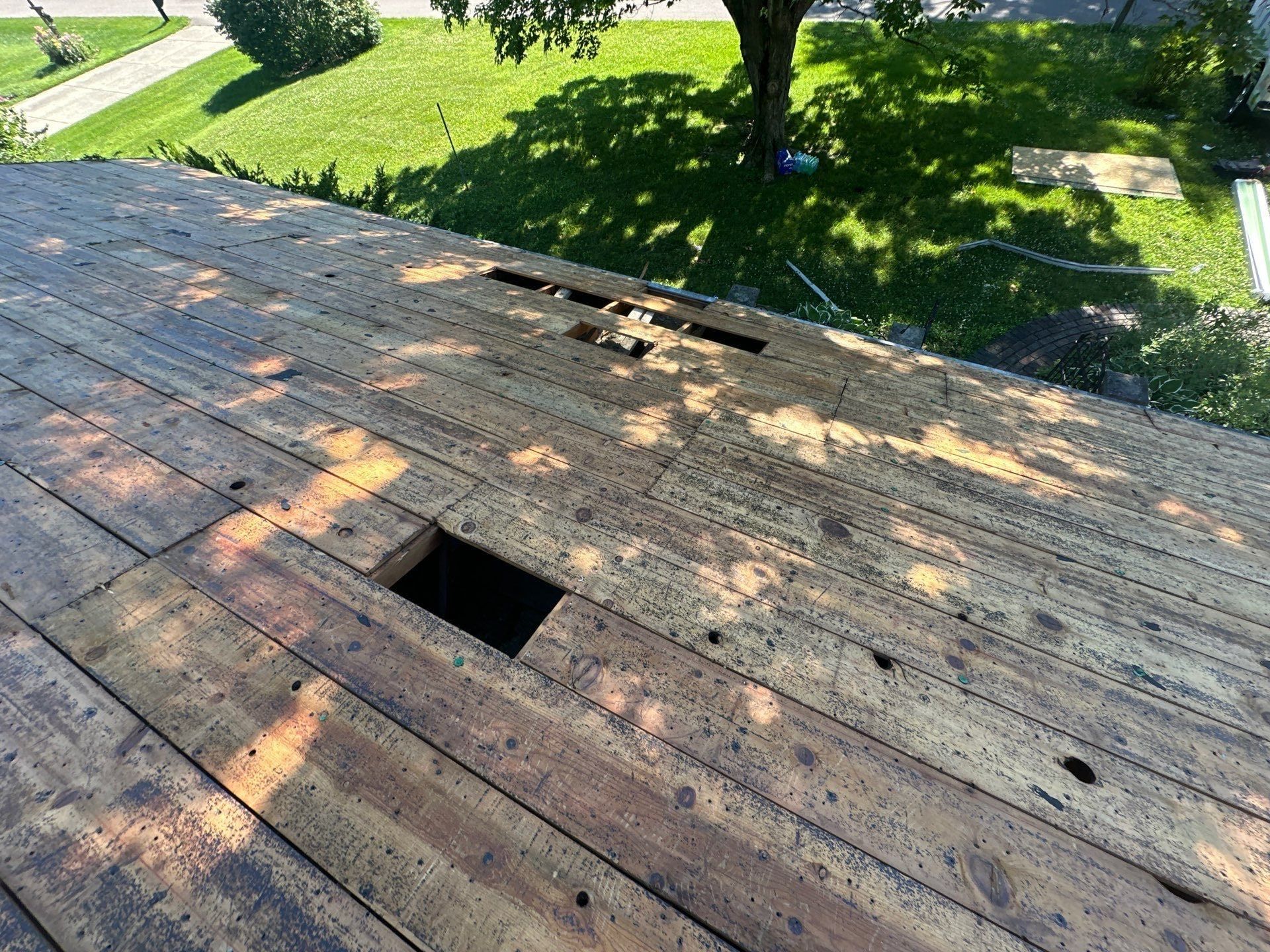 The house roof torn off to the old board deck, with holes where boards had failed, Beavercreek, Ohio.