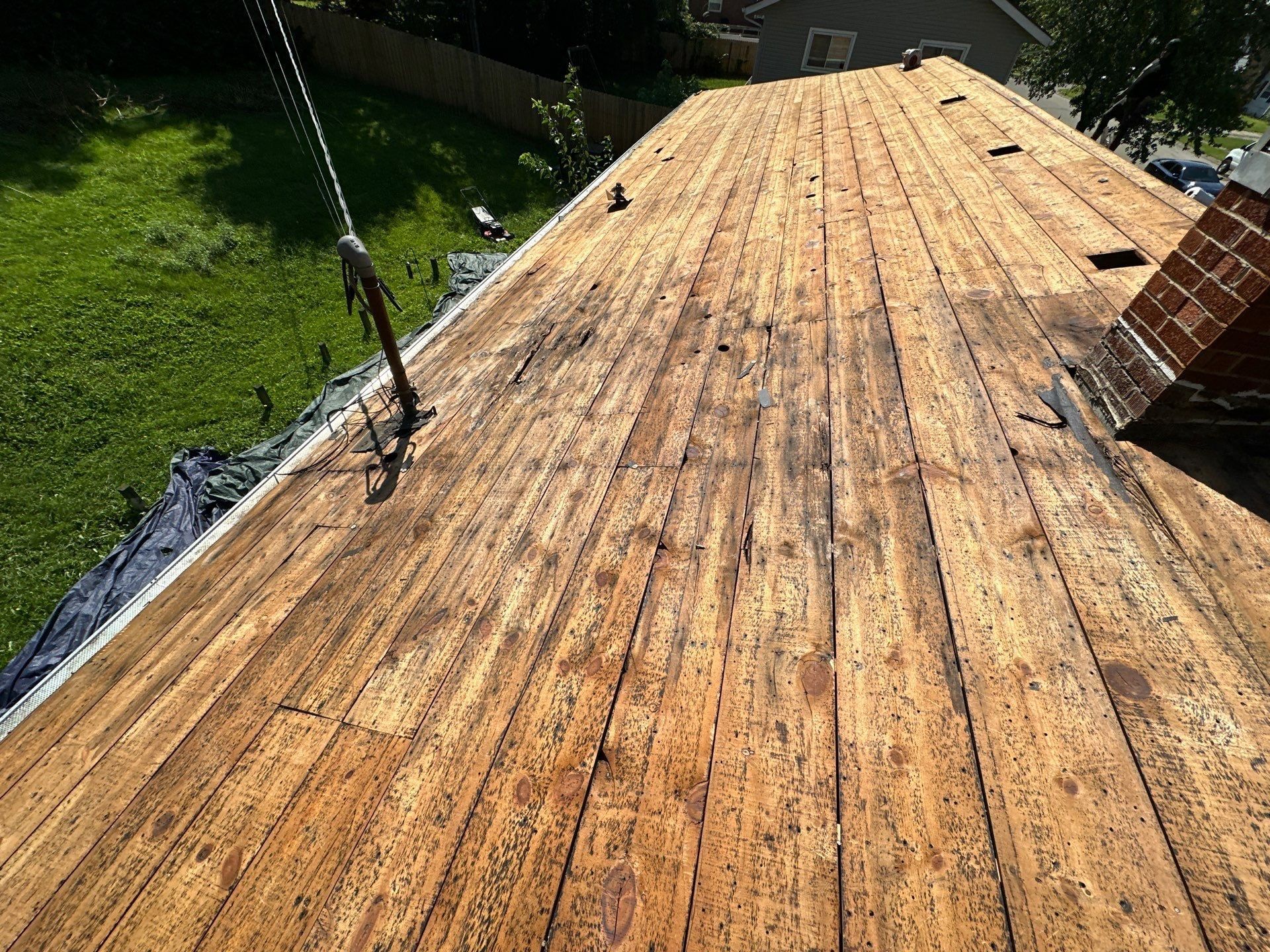The 1x board deck cleaned to bare wood beside the brick chimney, Fairborn, Ohio.