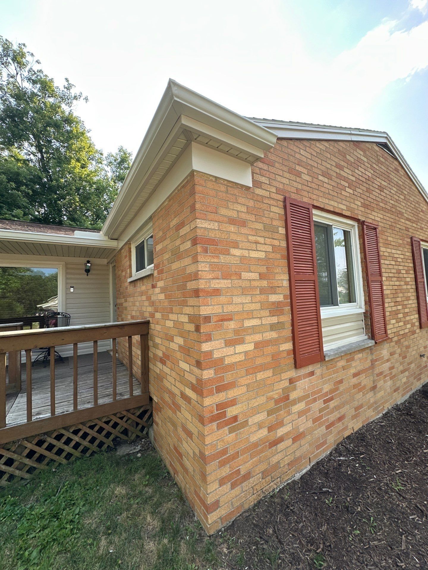 New seamless gutter on the front corner of the house, above the shuttered window, Kettering, Ohio.