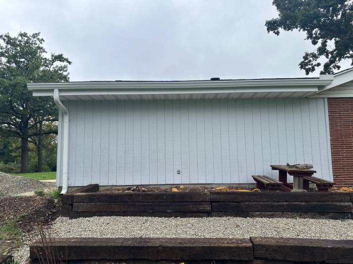 A white-sided wall with a new seamless gutter along its eave and a downspout at the end, West Carrollton, Ohio.