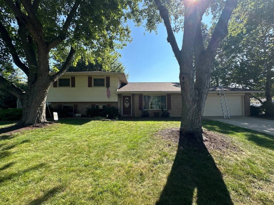 The finished house roof from the front lawn, under two shade trees, Dayton, Ohio.