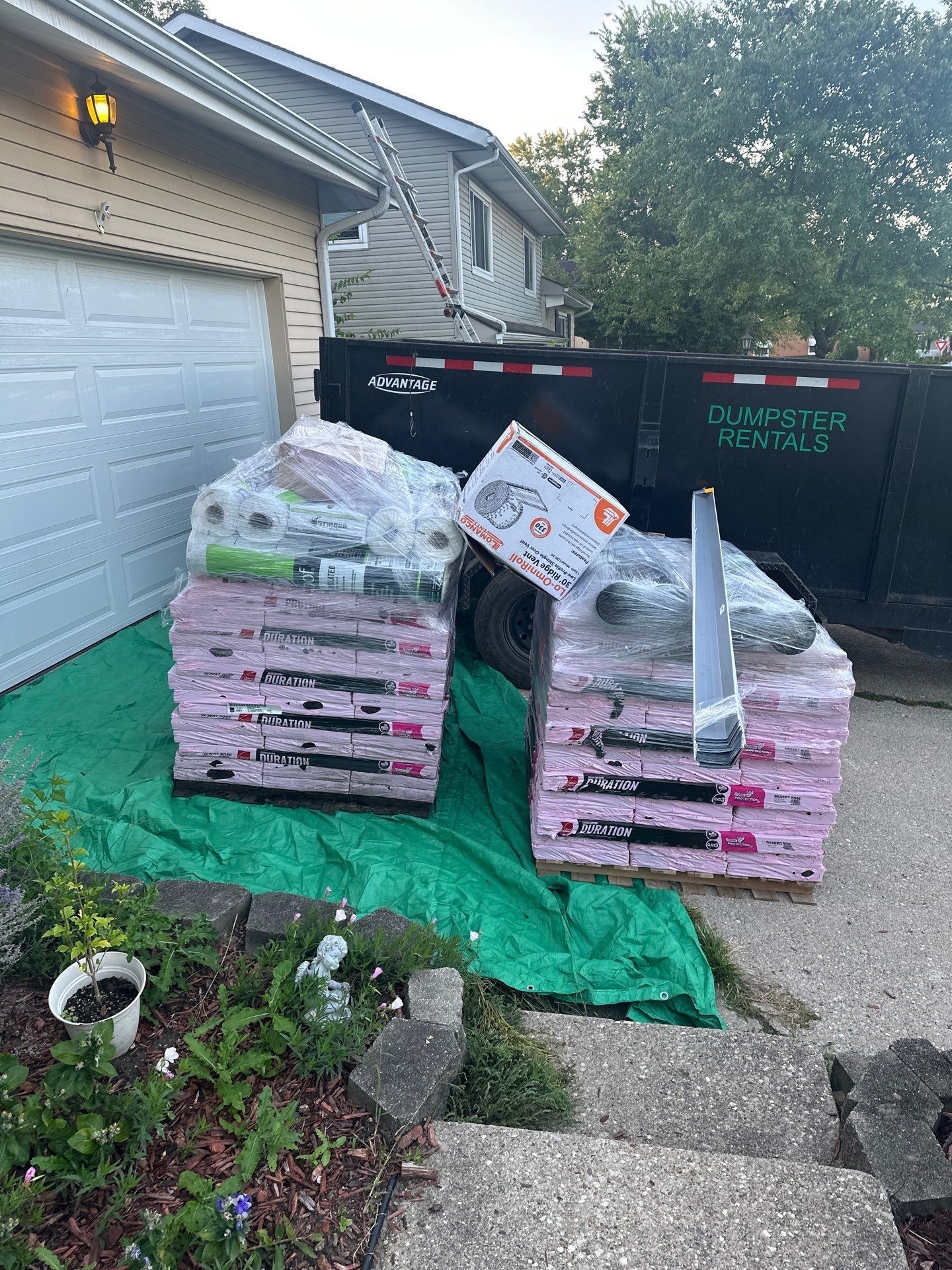 Two pallets of Duration shingles and supplies in front of the garage, Fairborn, Ohio.