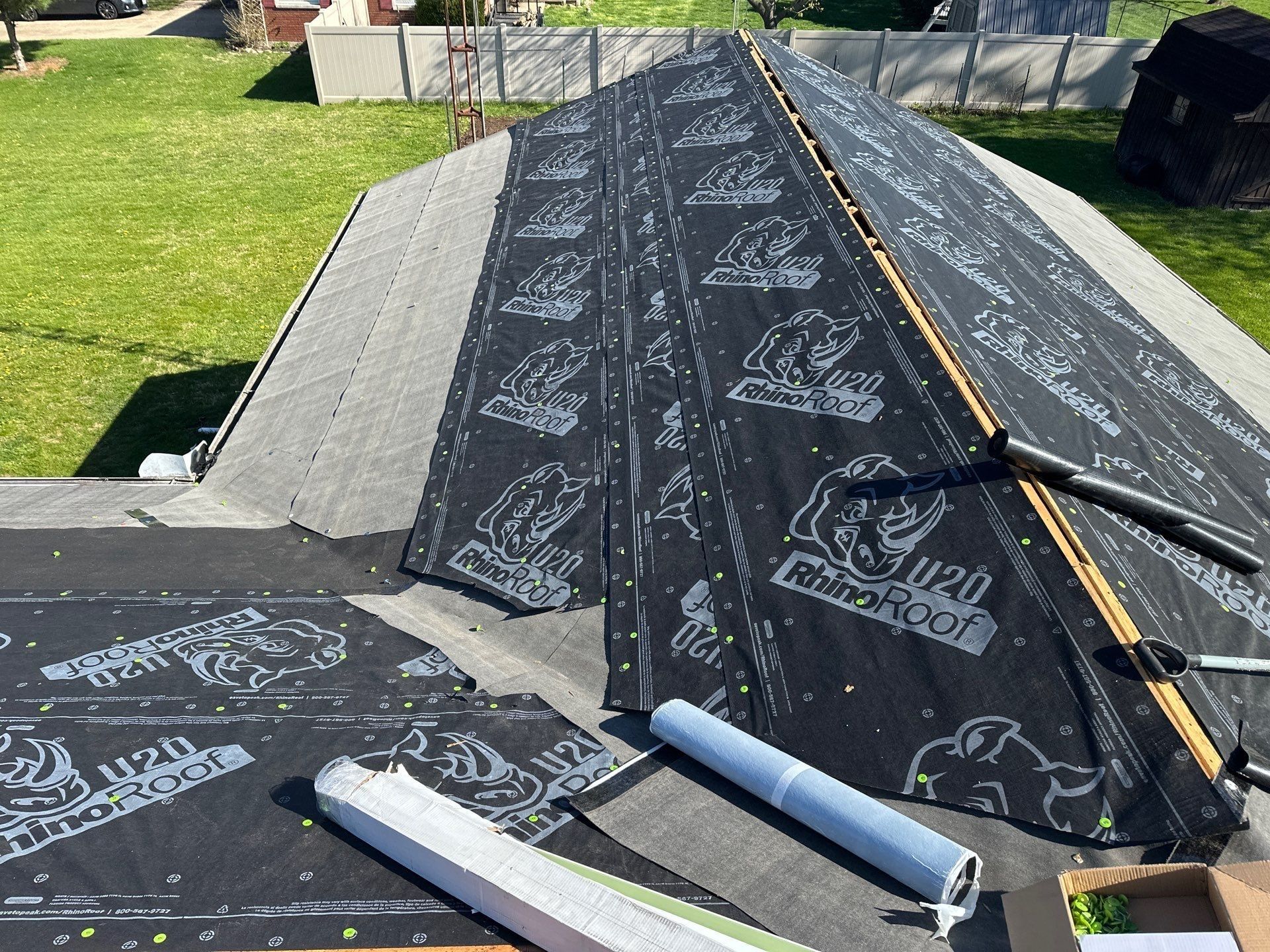 Synthetic underlayment rolled over the deck with grey membrane along the eaves, Beavercreek, Ohio.