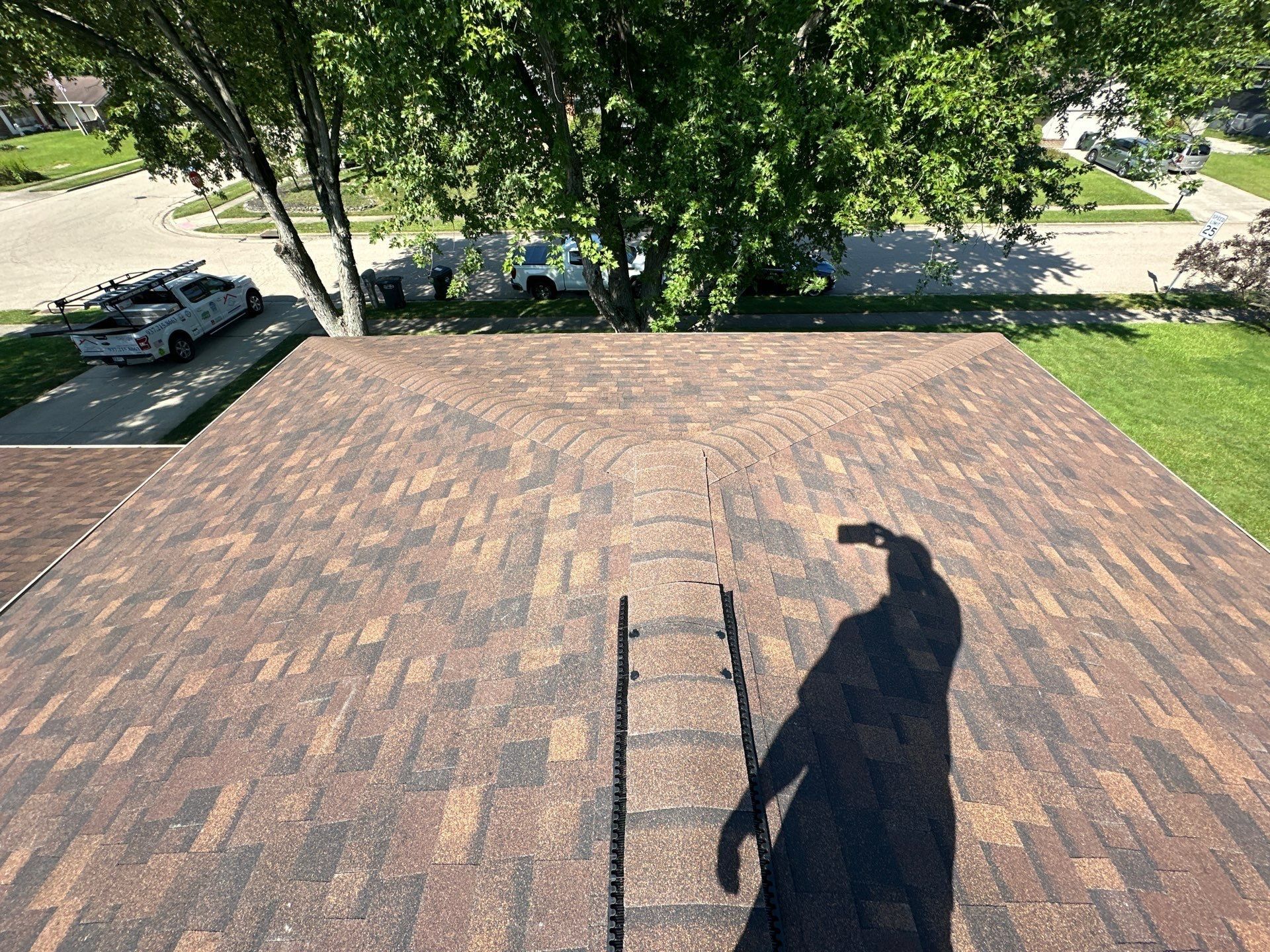 The finished hip roof and ridge vent from above, looking to the street, Dayton, Ohio.