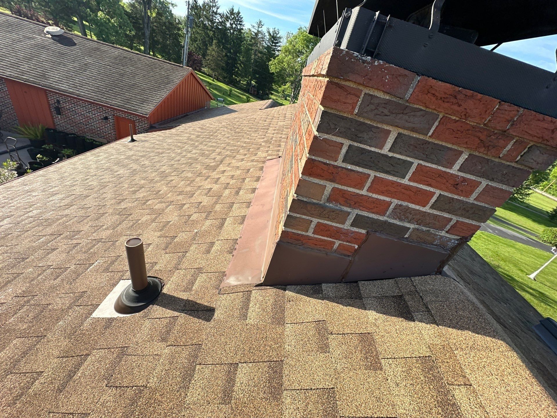 New shingles around the brick chimney and a pipe boot, Clayton, Ohio.