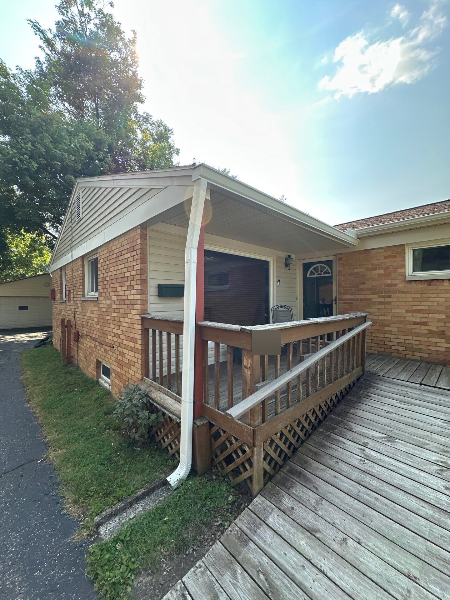 New white seamless gutter and downspout at the front porch, Kettering, Ohio.