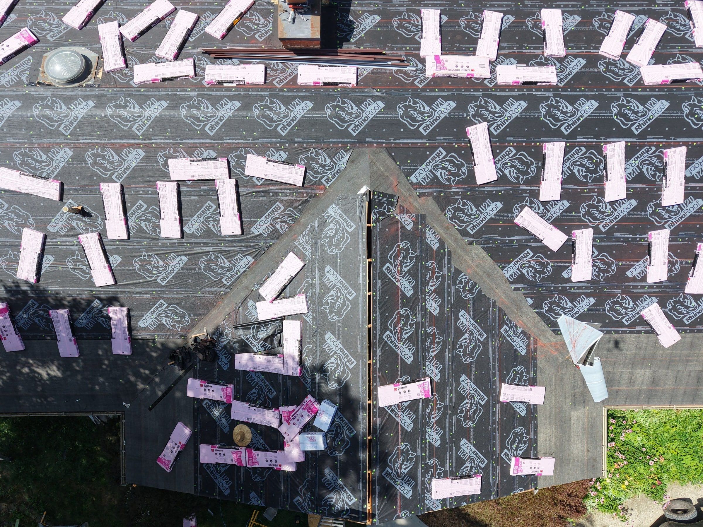 Bundles staged on both planes of the front gable over the underlayment, Beavercreek, Ohio.